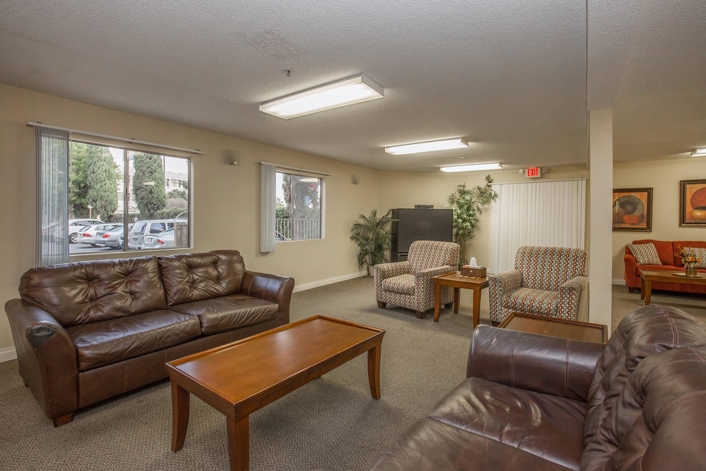 New Horizon Village Senior Apartment Homes community room with leather couches
