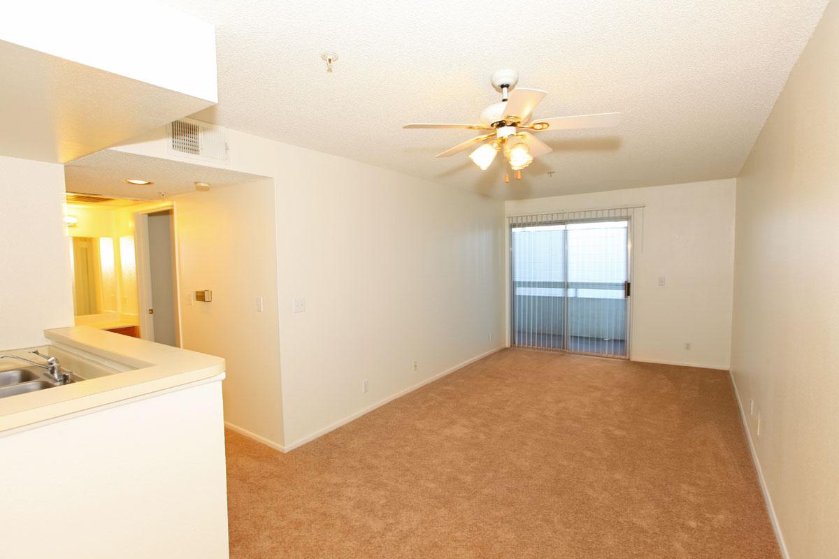 Carpeted living room with sliding glass doors