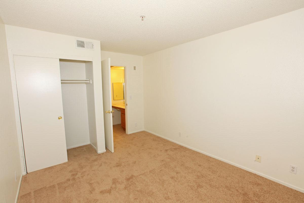 Bedroom with open sliding closet doors