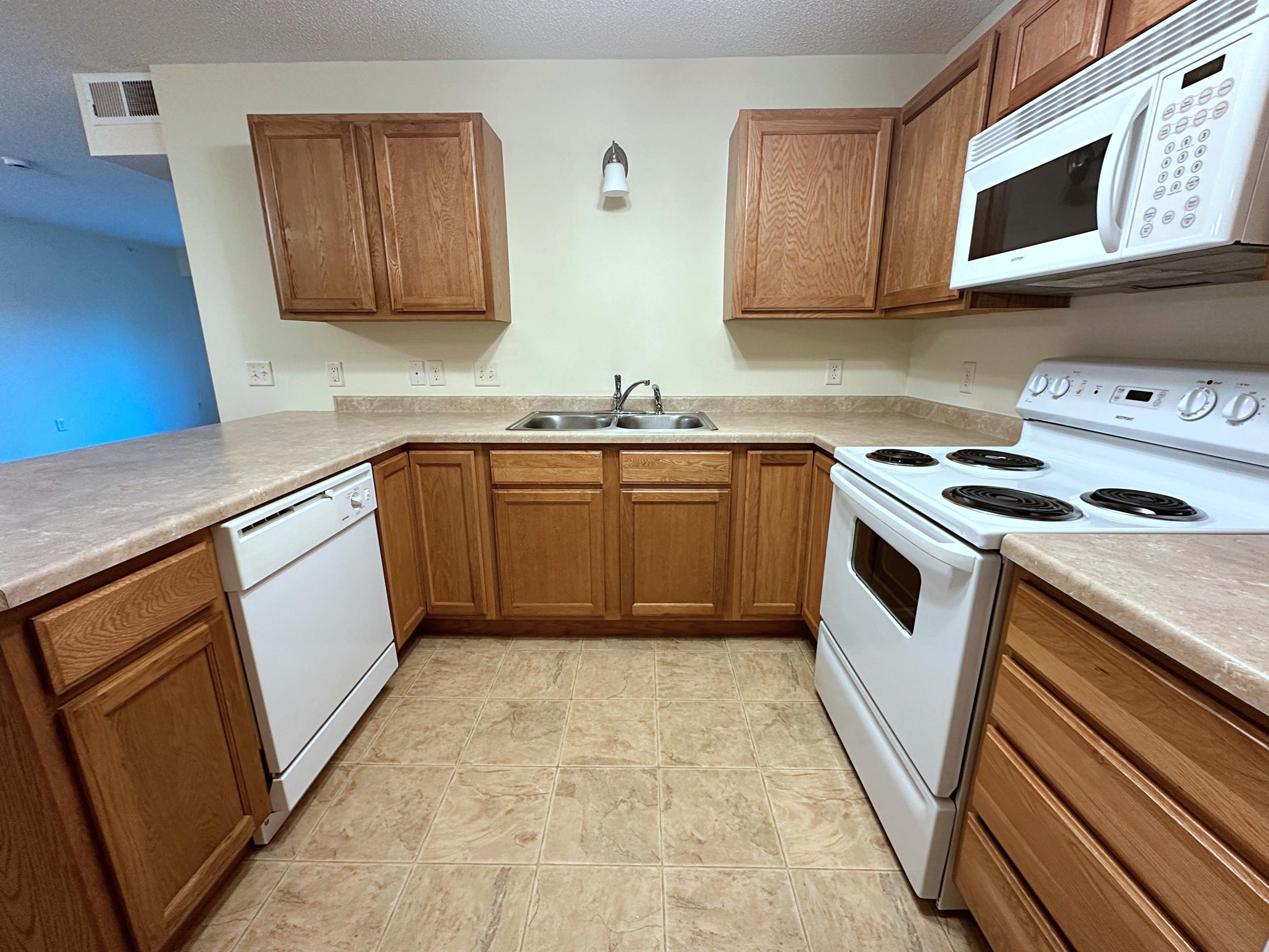 a stove top oven sitting inside of a kitchen