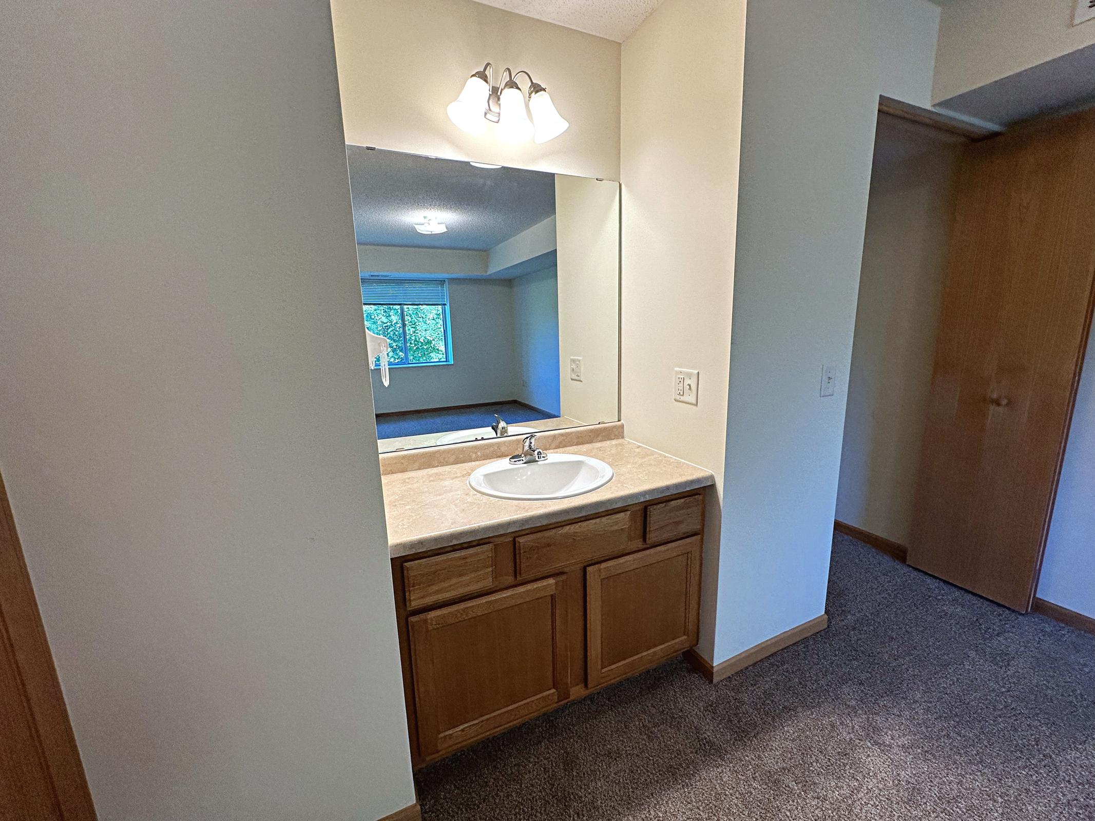 a kitchen with a sink and a mirror