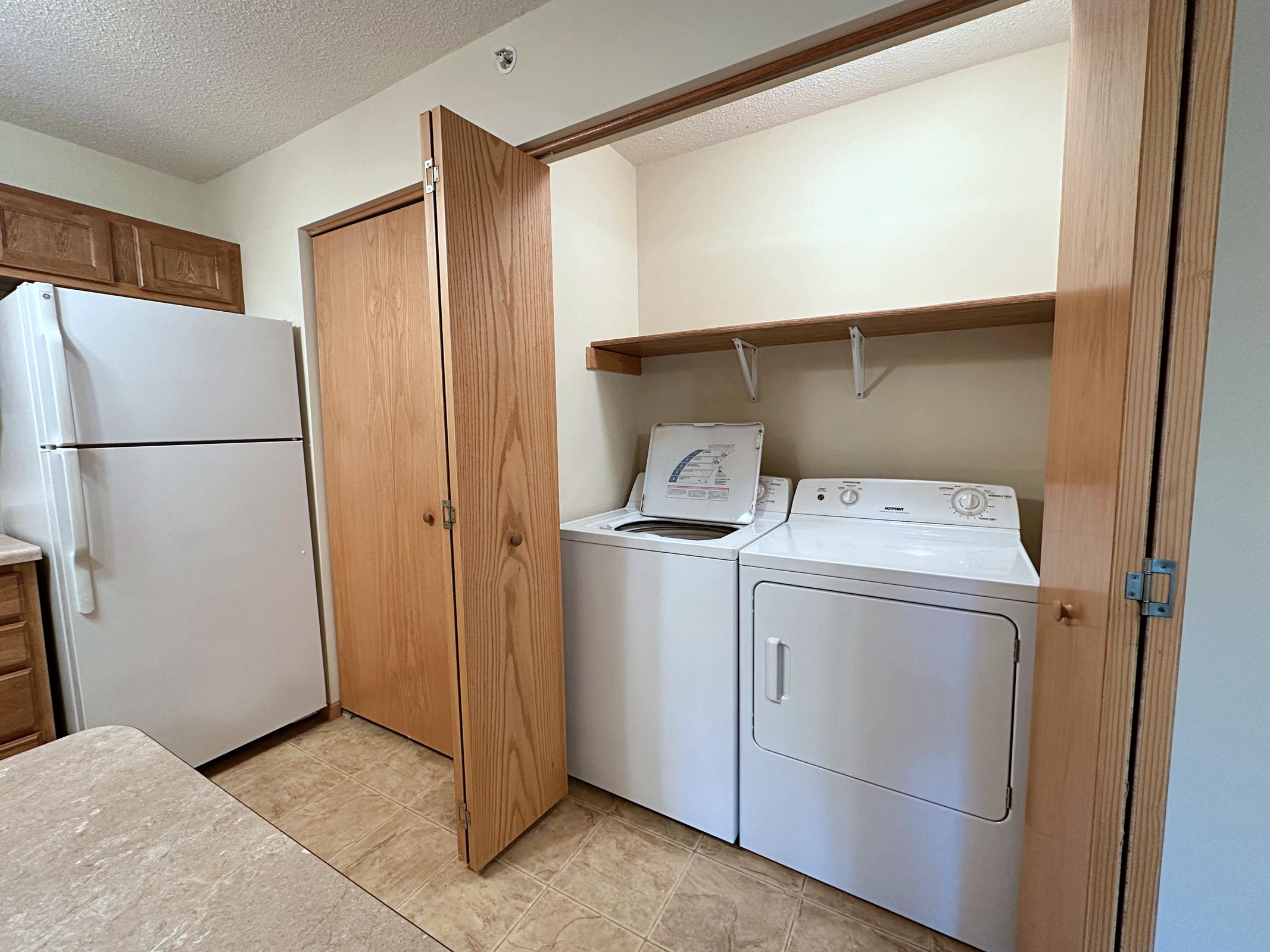 a kitchen with wooden cabinets and a refrigerator