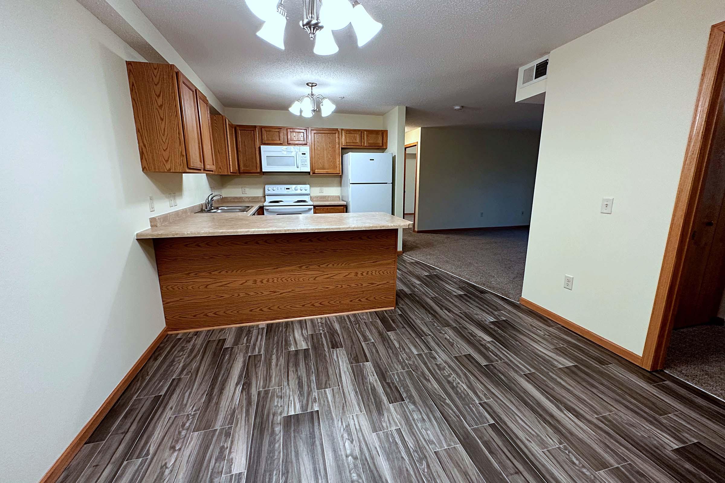 a bedroom with a wooden floor