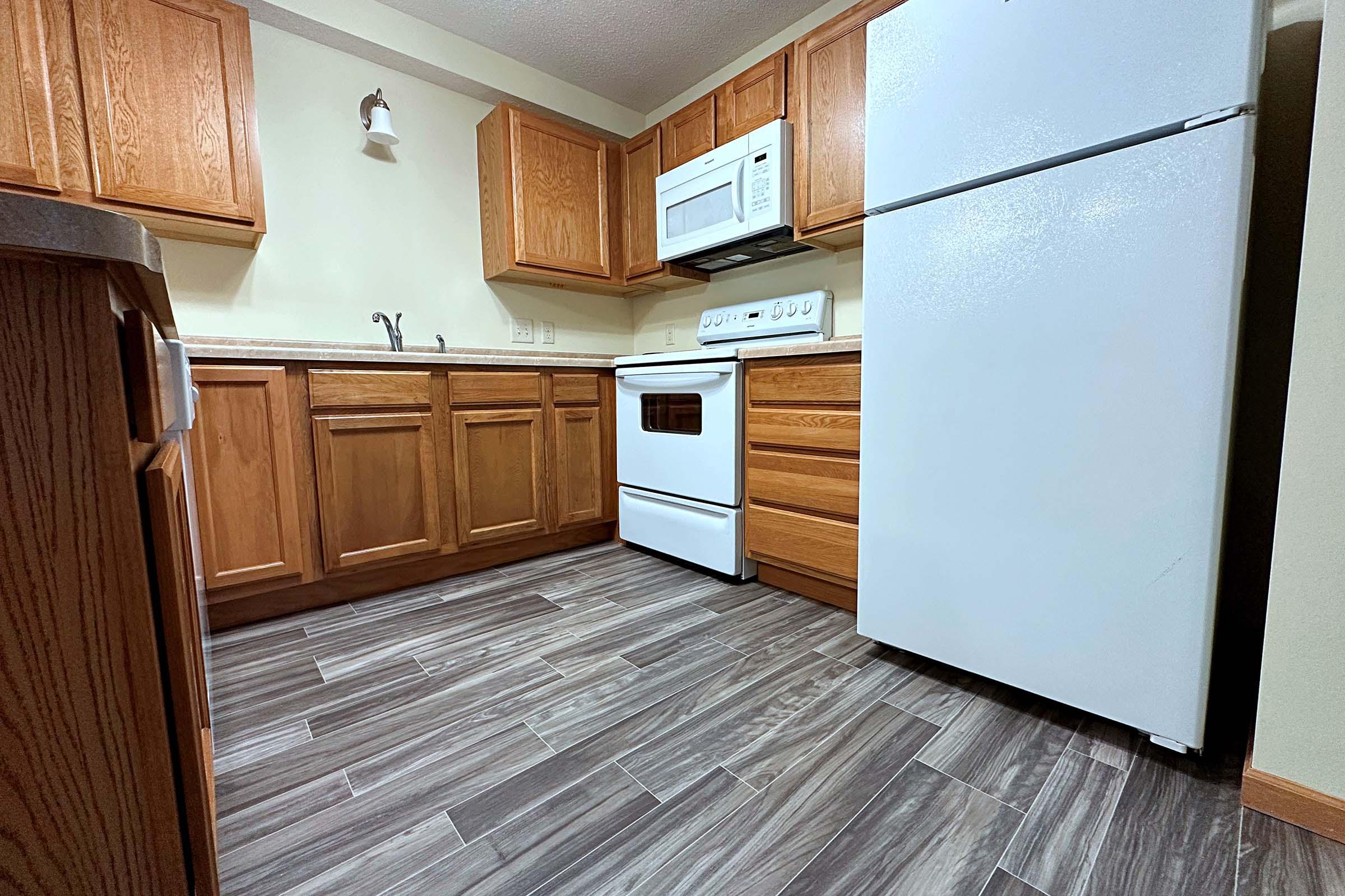 a kitchen with a stove and a refrigerator