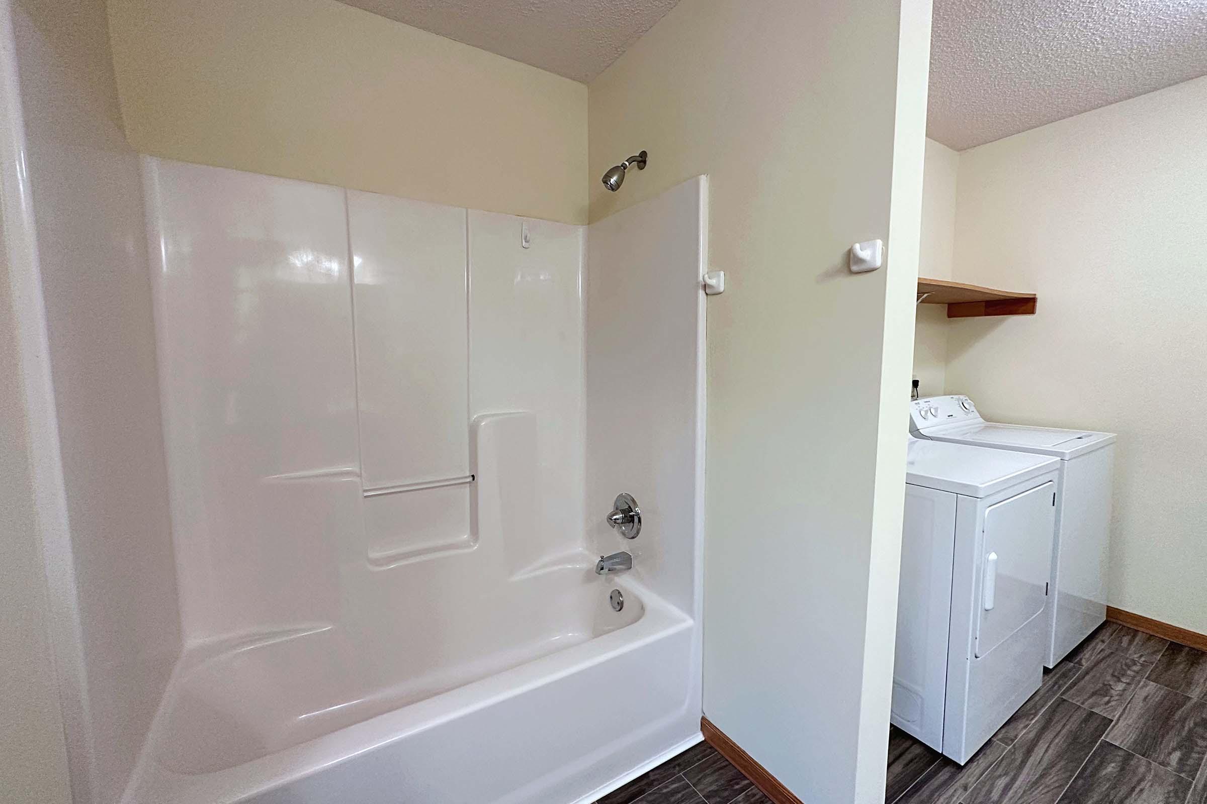 a shower that has a sink and a mirror