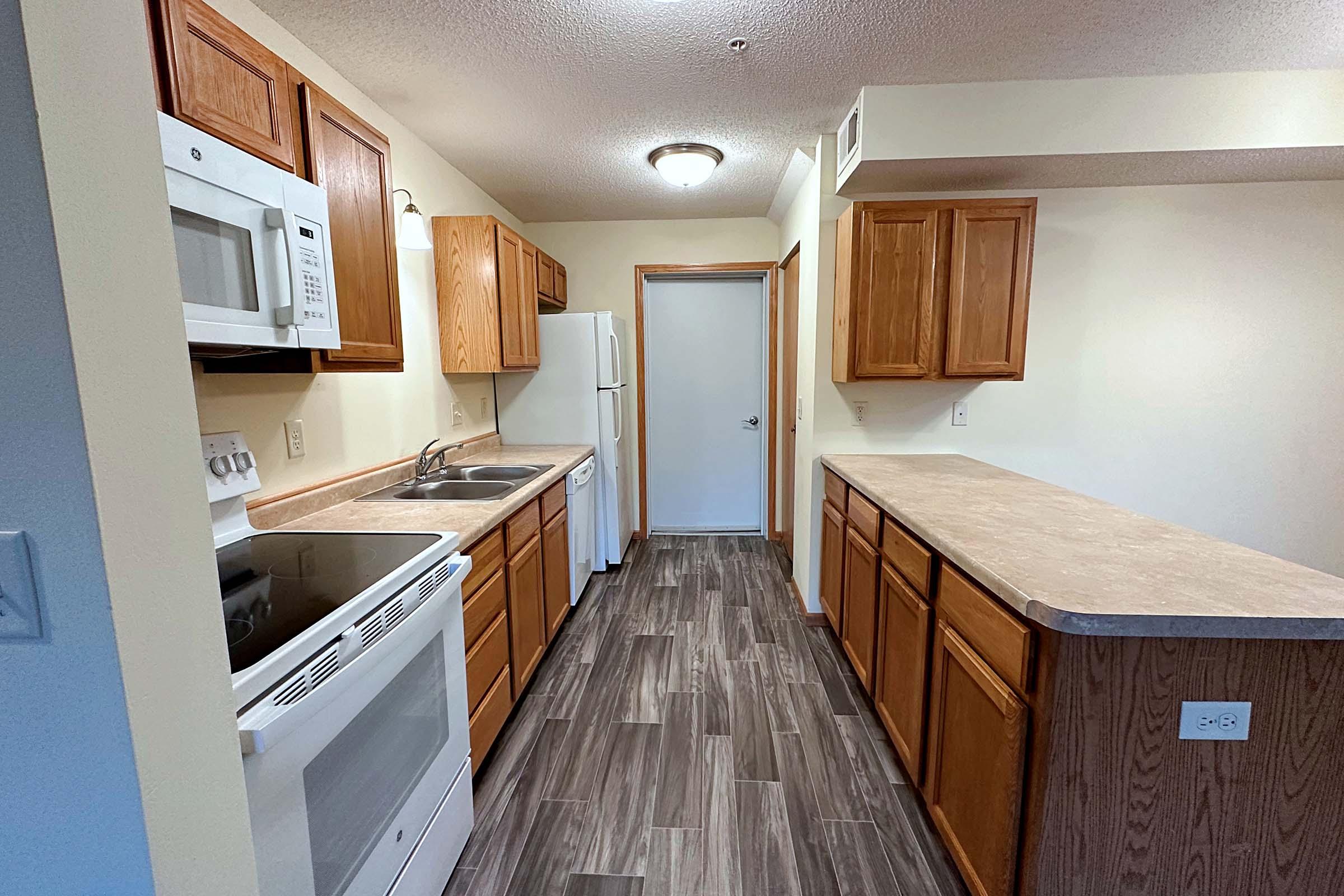 a kitchen with a sink and a refrigerator