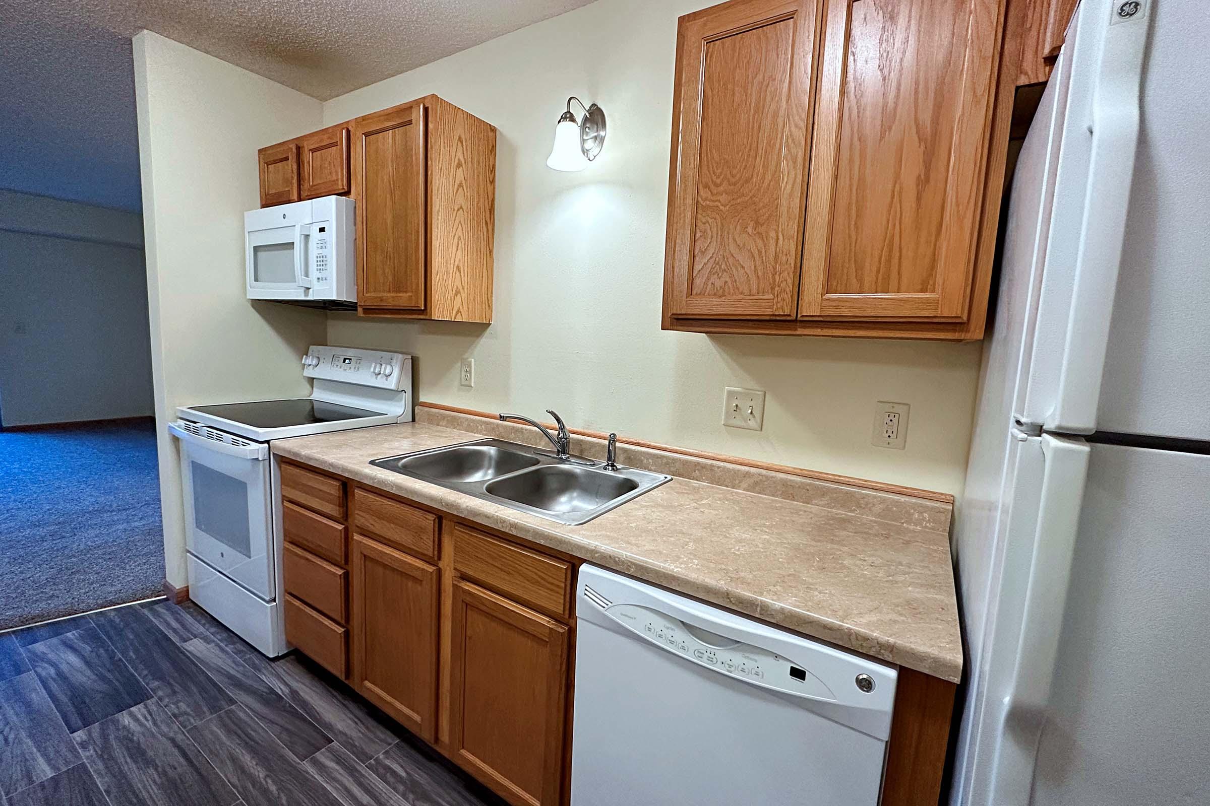 a kitchen with wooden cabinets and a sink