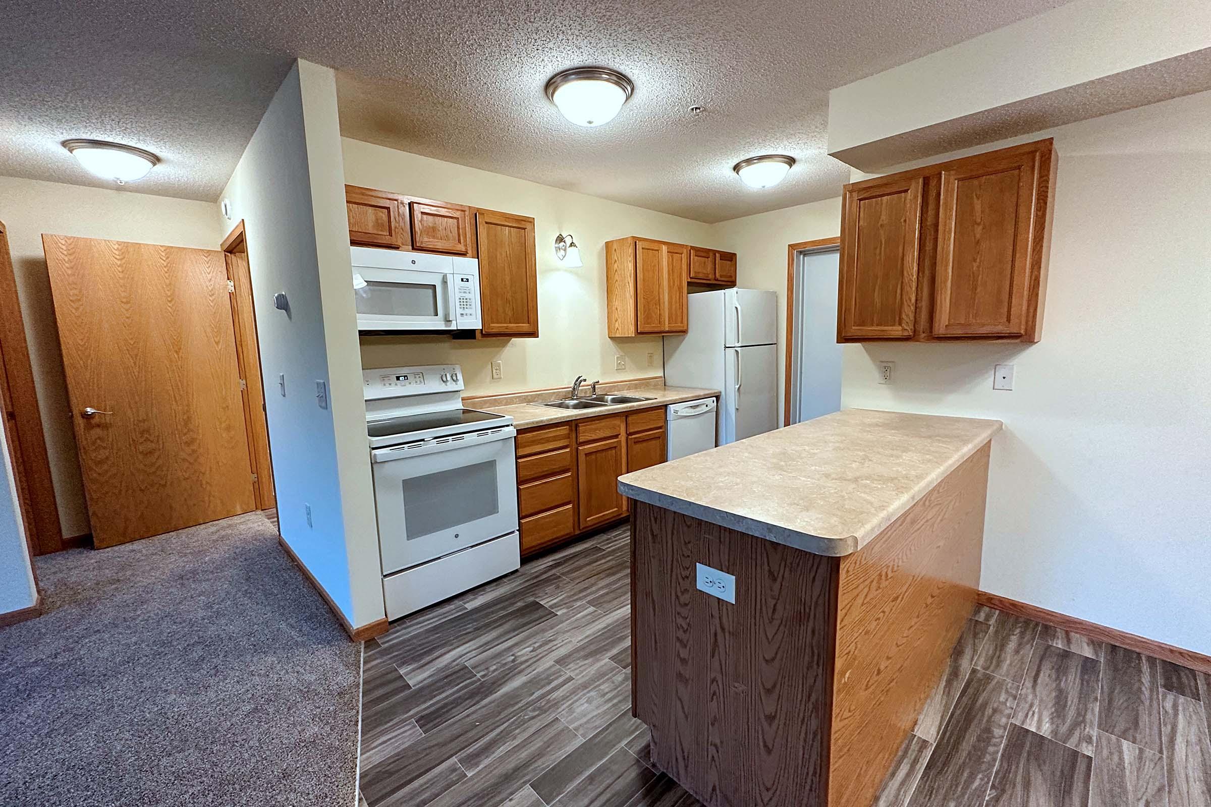 a kitchen with wooden cabinets in a room