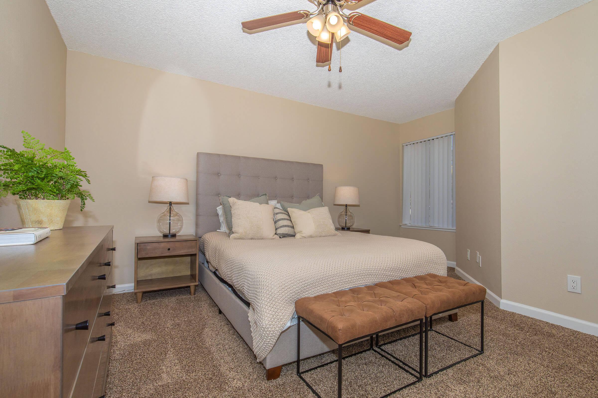 a bedroom with a bed and desk in a small room