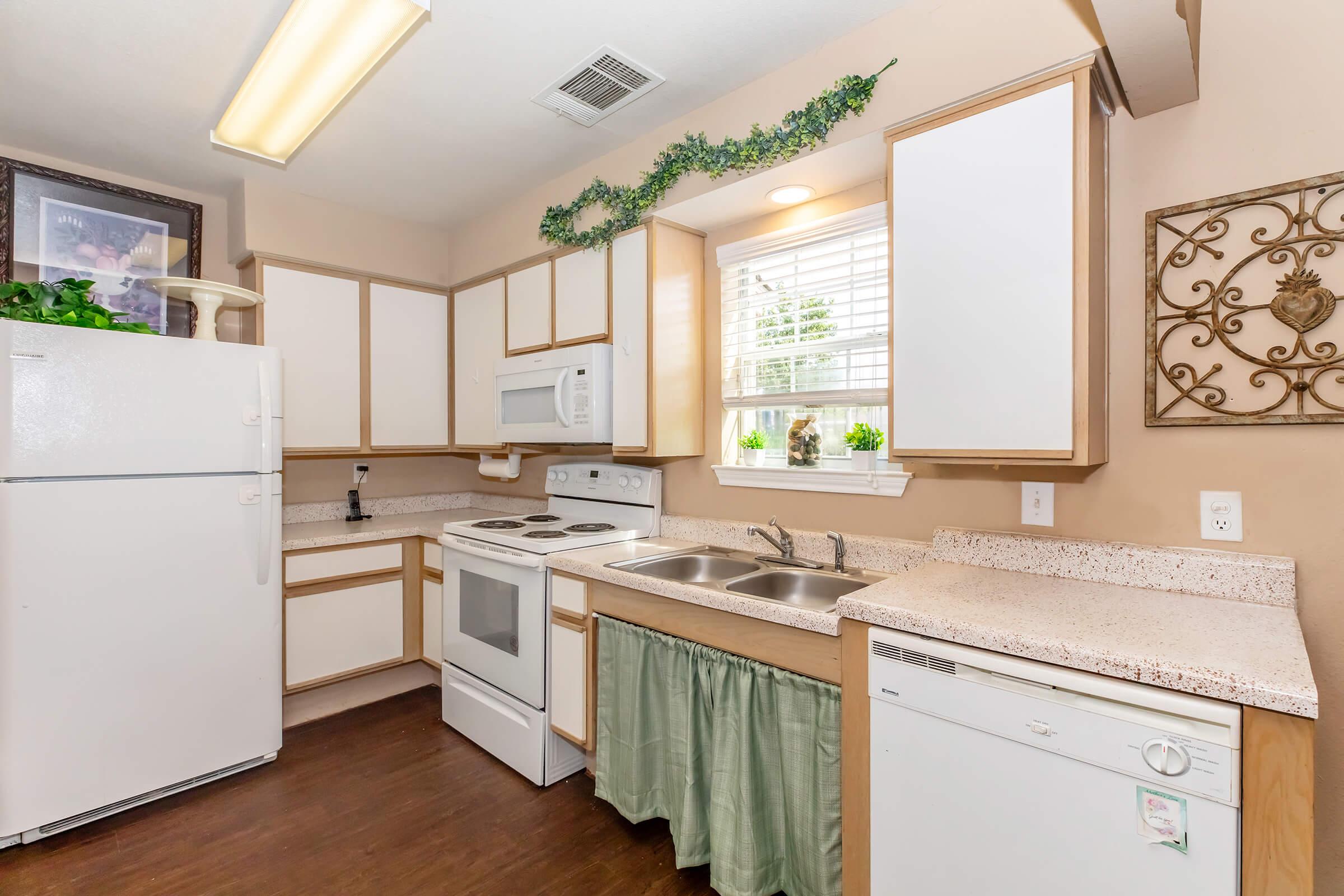 a kitchen with wooden cabinets