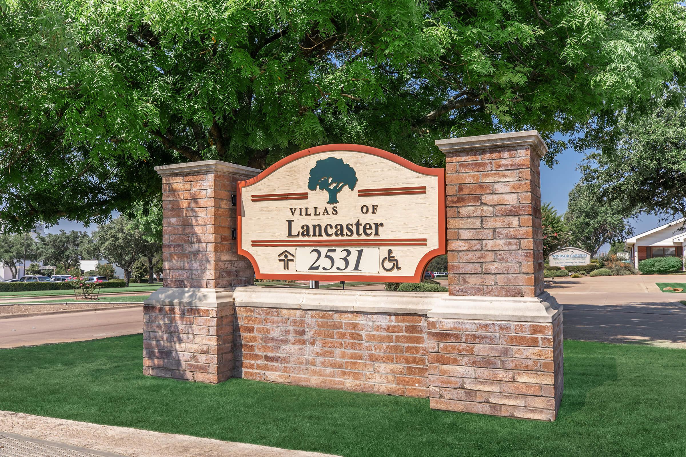 a sign in front of a brick building