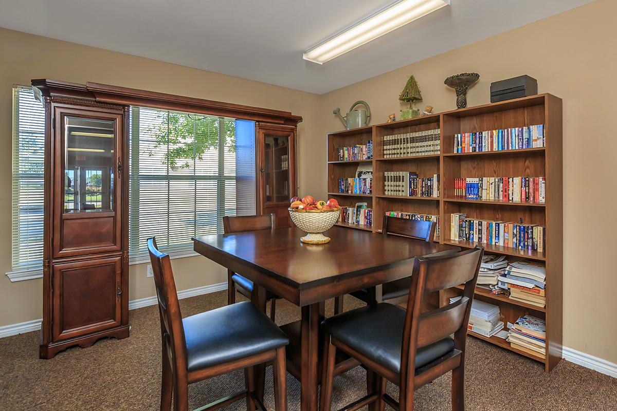 a living room filled with furniture and a book shelf