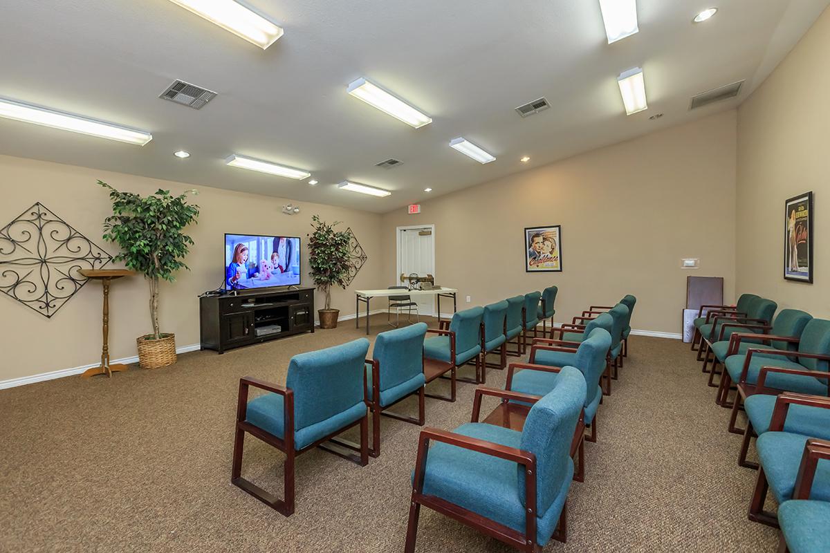 a living room filled with furniture and a flat screen tv