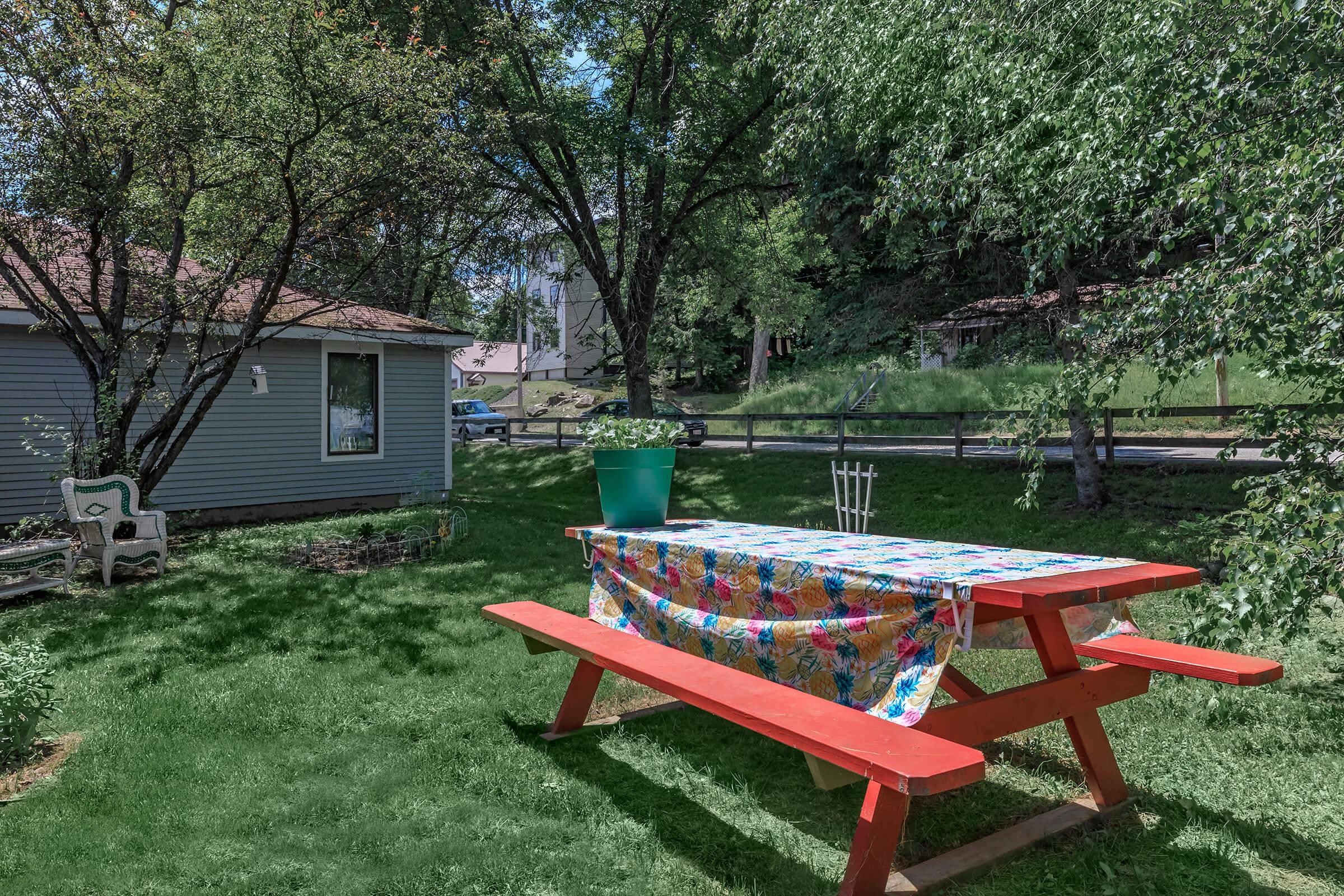 a couple of lawn chairs sitting on top of a picnic table