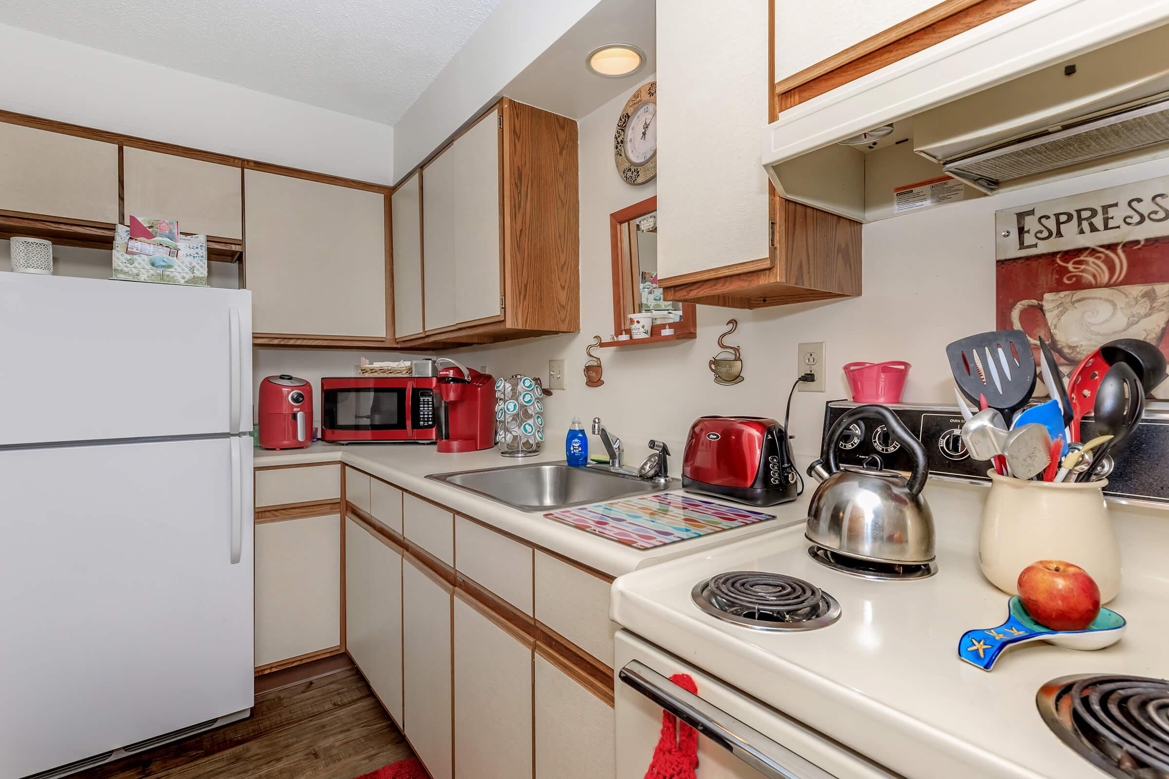 a kitchen with a stove sink and refrigerator