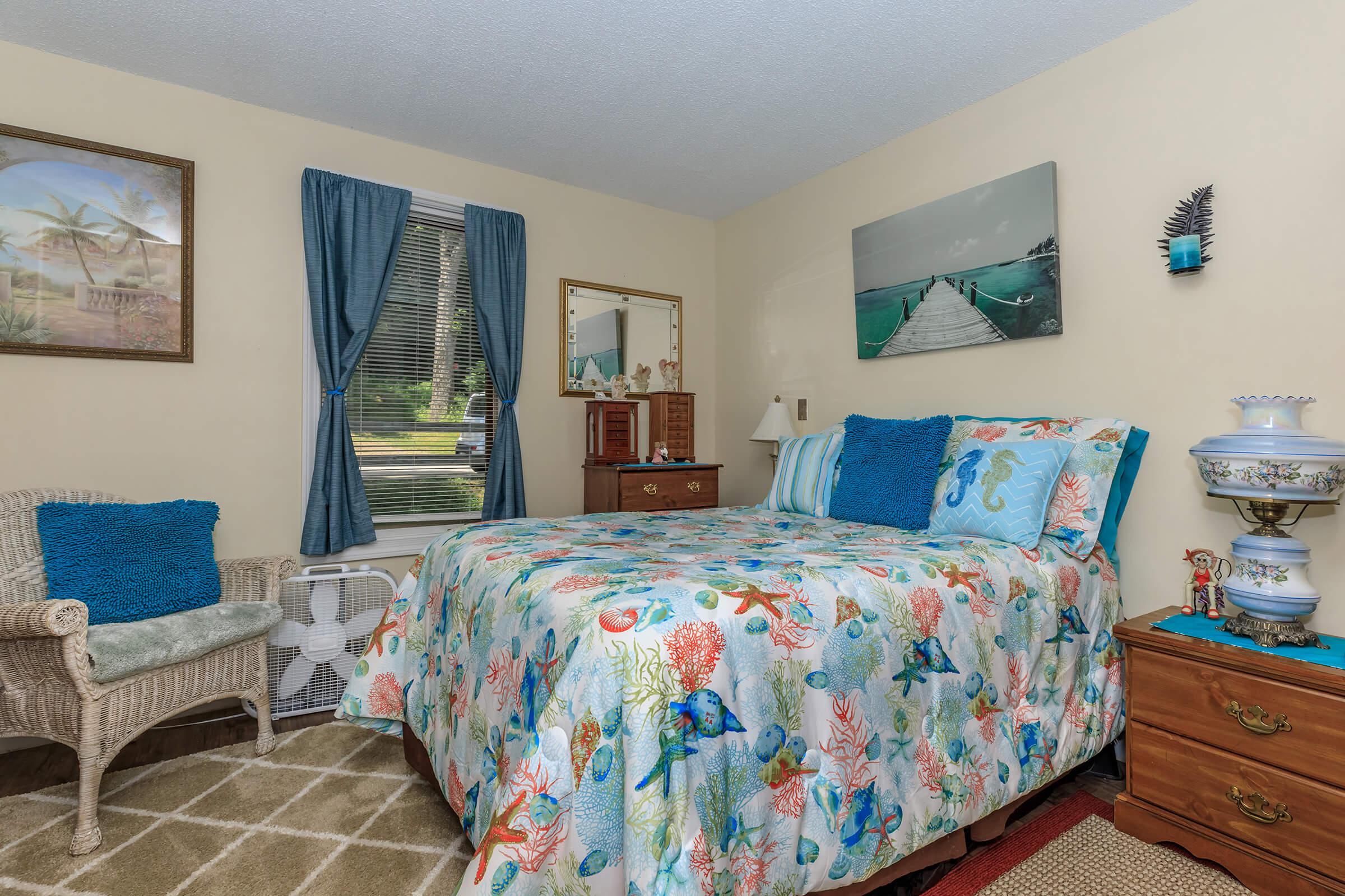 a colorful living room with blue walls and a bed