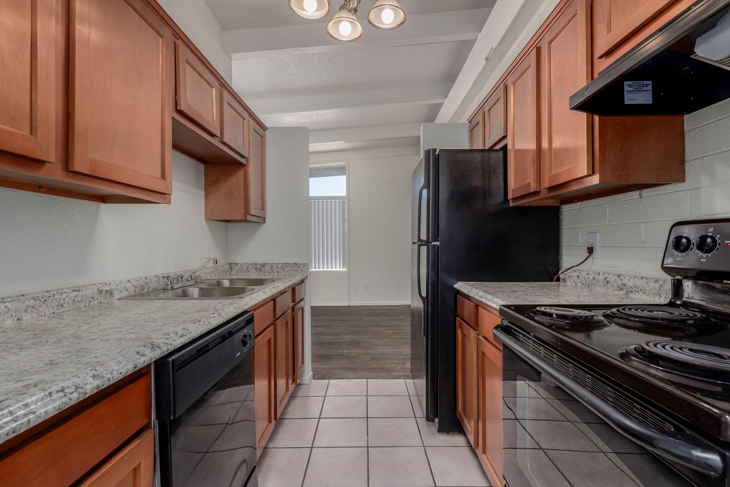 a modern kitchen with stainless steel appliances and wooden cabinets