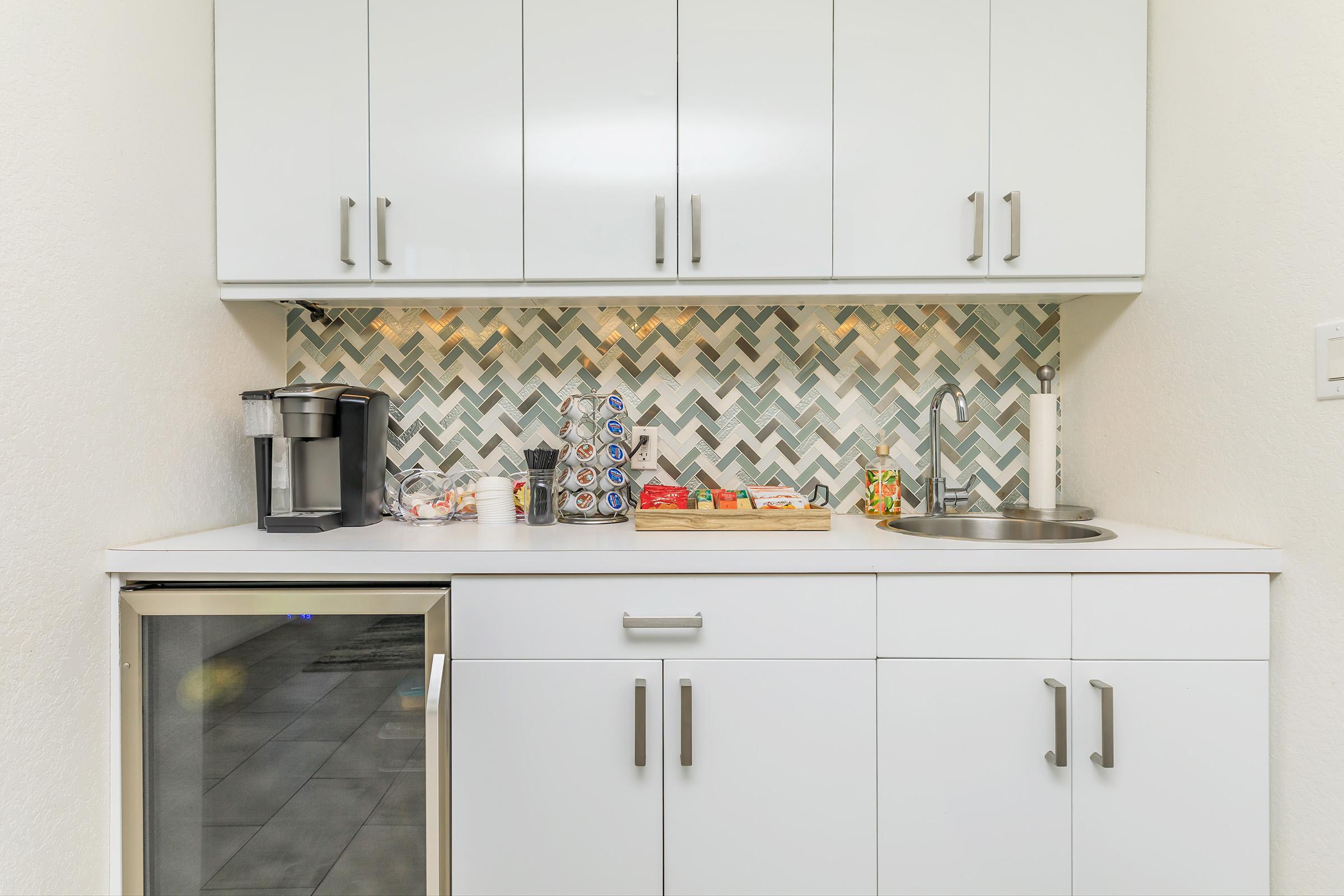 a kitchen with a sink and a refrigerator