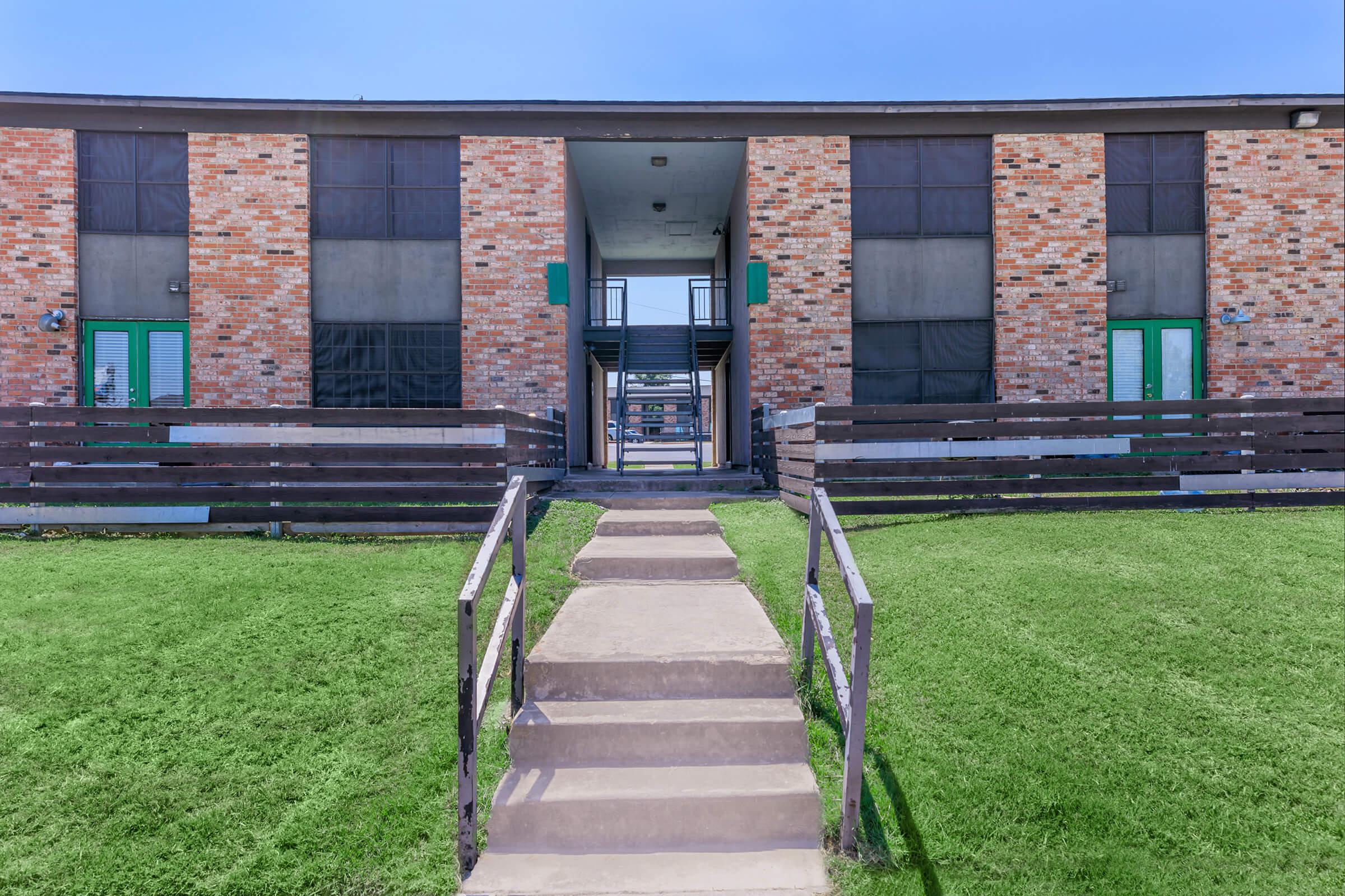 a bench in front of a brick building