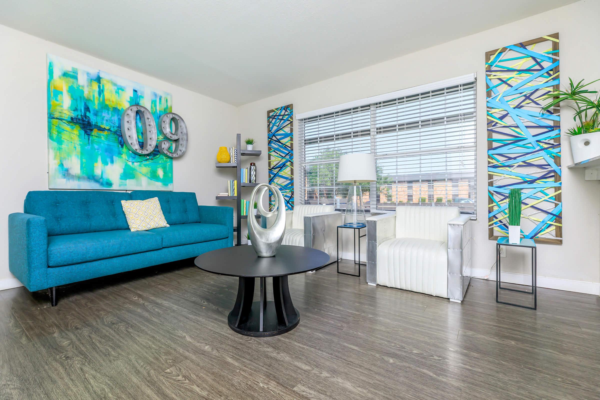 a living room filled with furniture and a large window