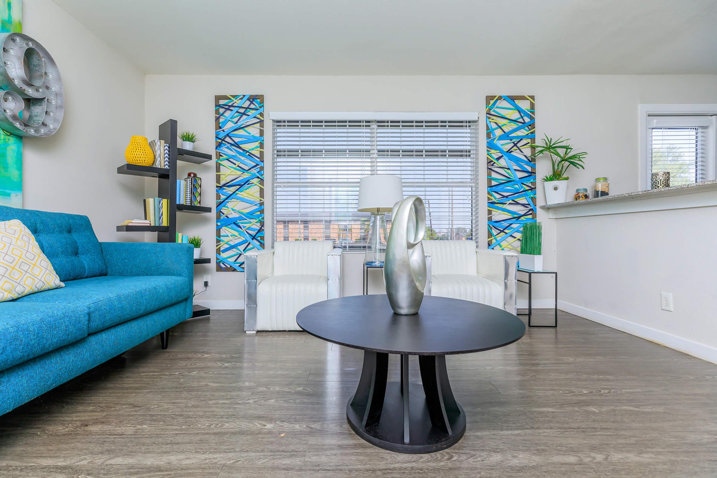 a living room with a blue chair