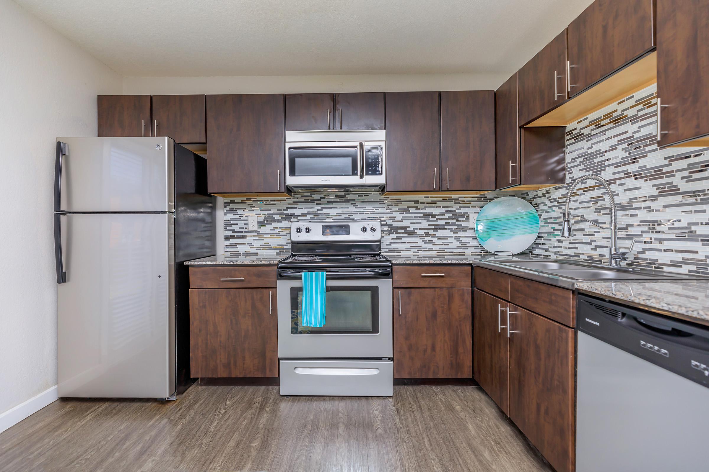 a kitchen with a stove and a refrigerator