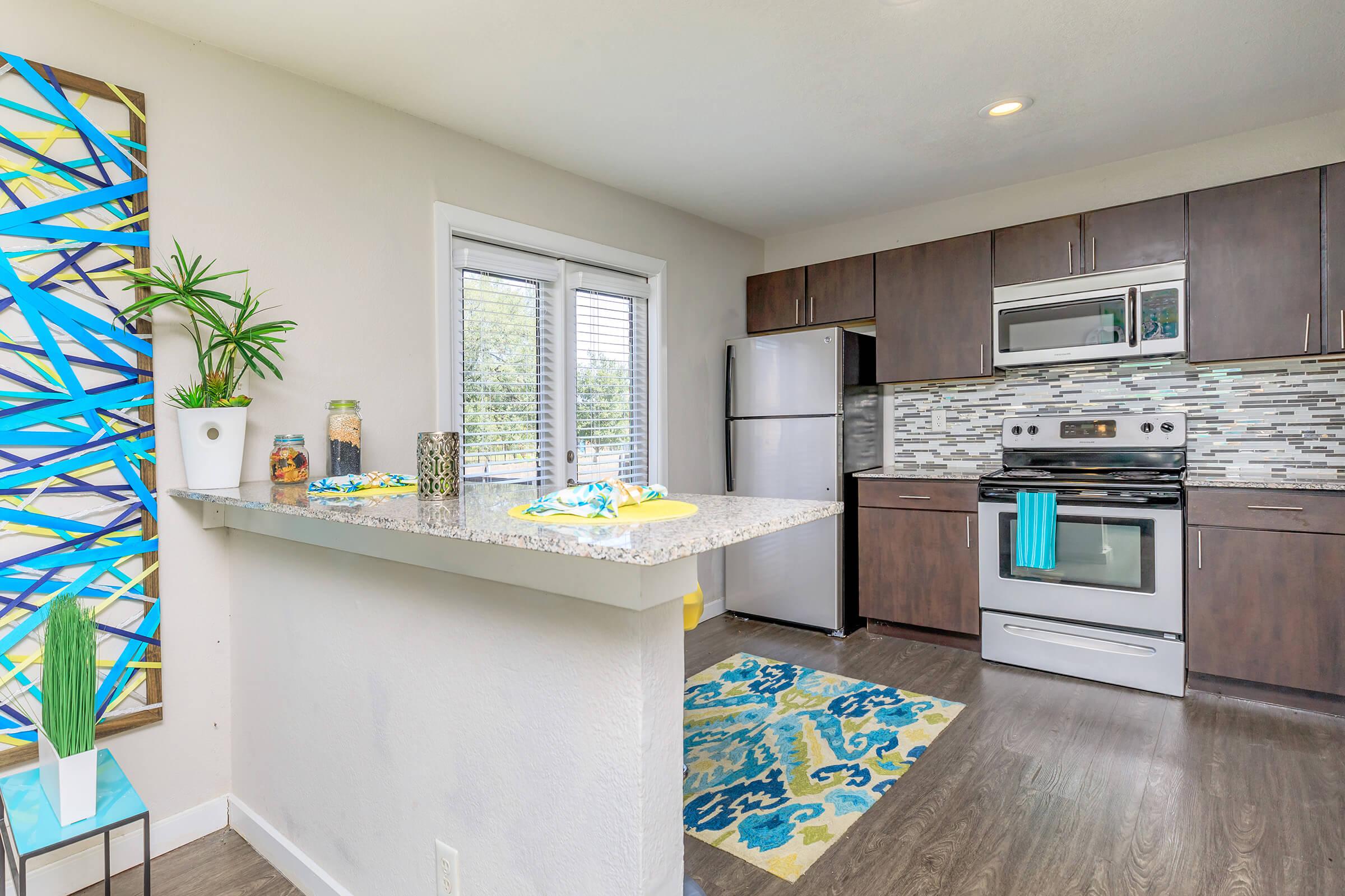 a kitchen with an island in the middle of a room