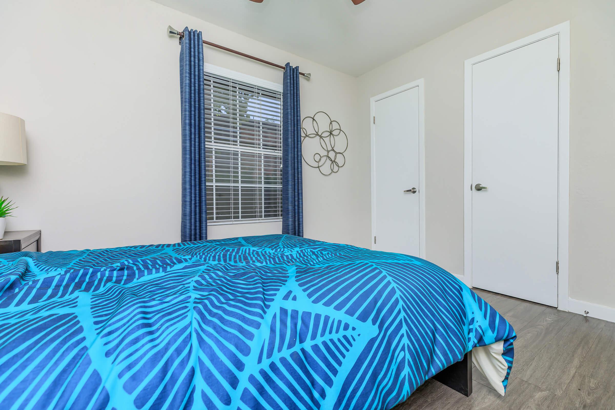 a bedroom with a blue umbrella