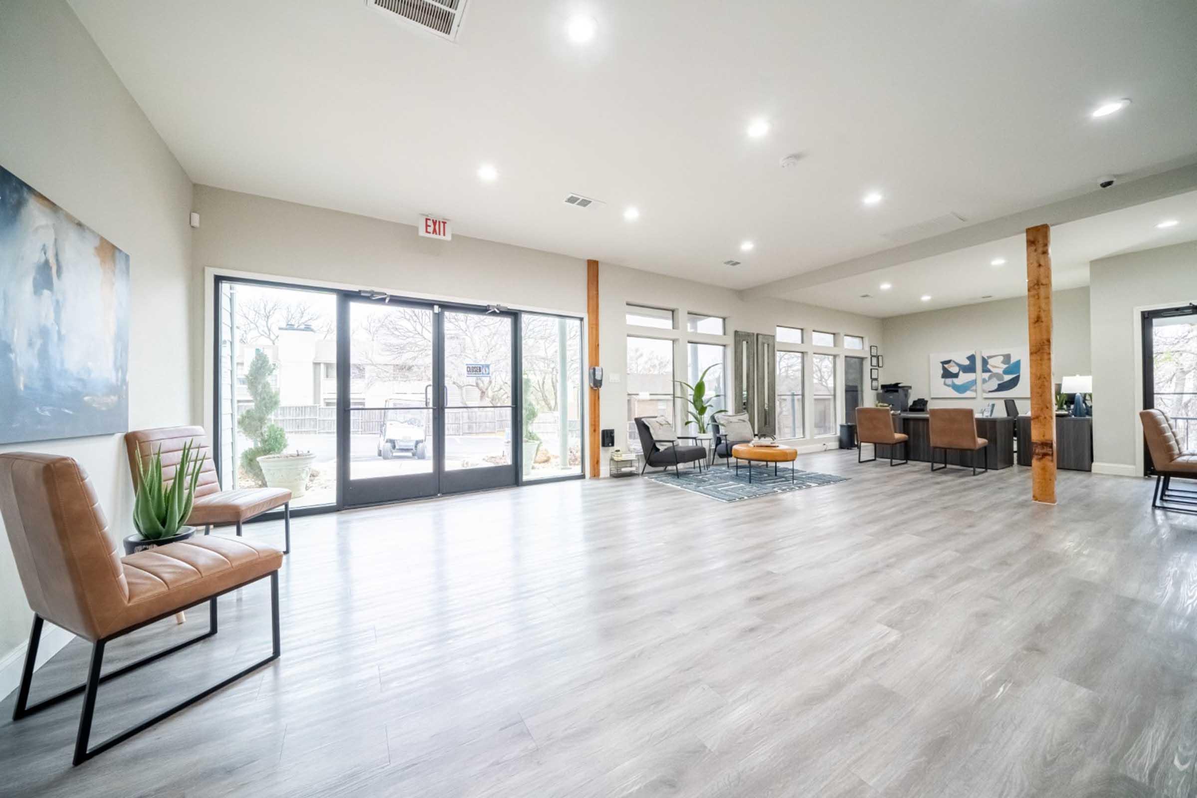 a living room filled with furniture and a large window