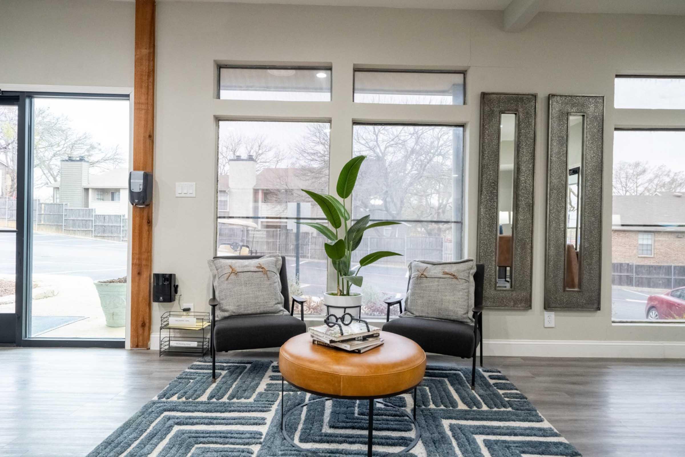 a living room filled with furniture and a large window