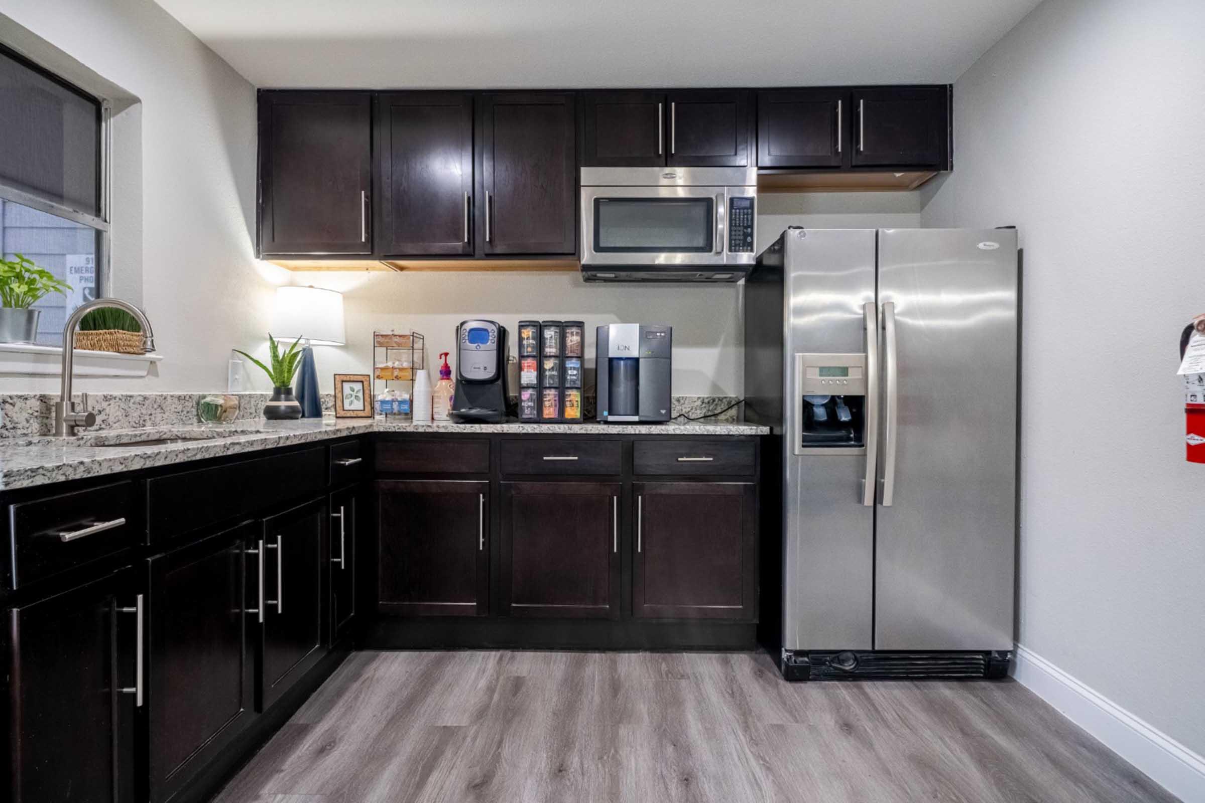 a kitchen with stainless steel appliances and wooden cabinets