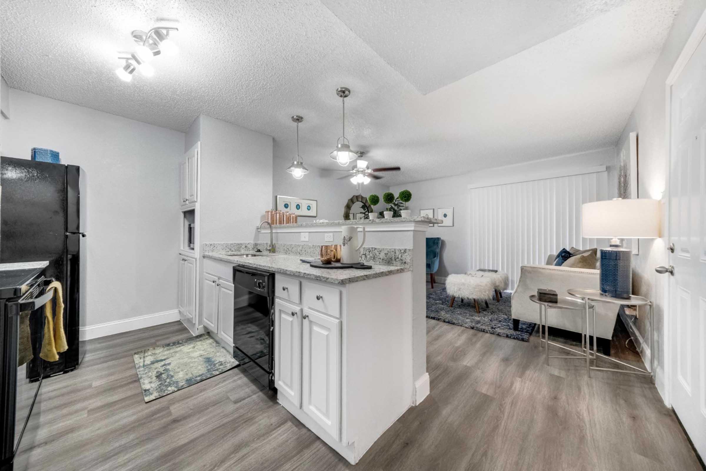 a kitchen with a wood floor in a room