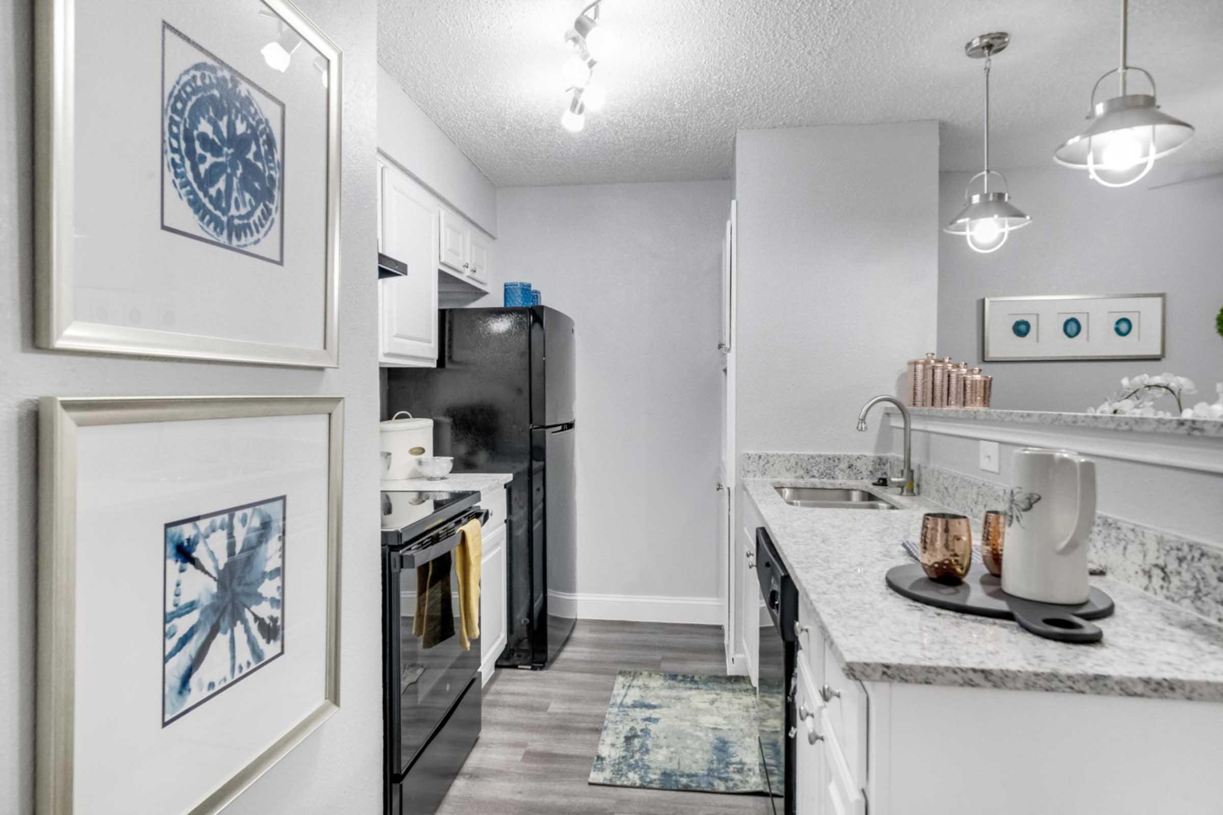 a kitchen with a sink and a refrigerator