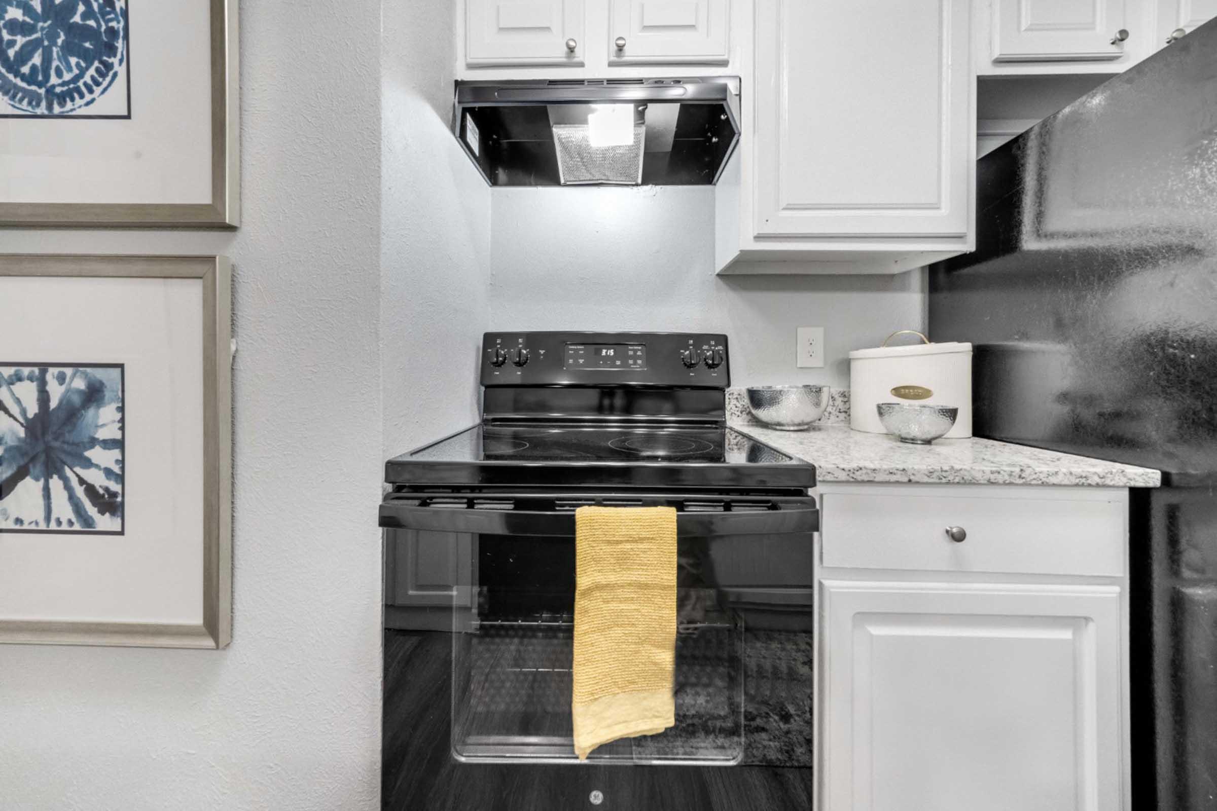 a stove top oven sitting inside of a kitchen