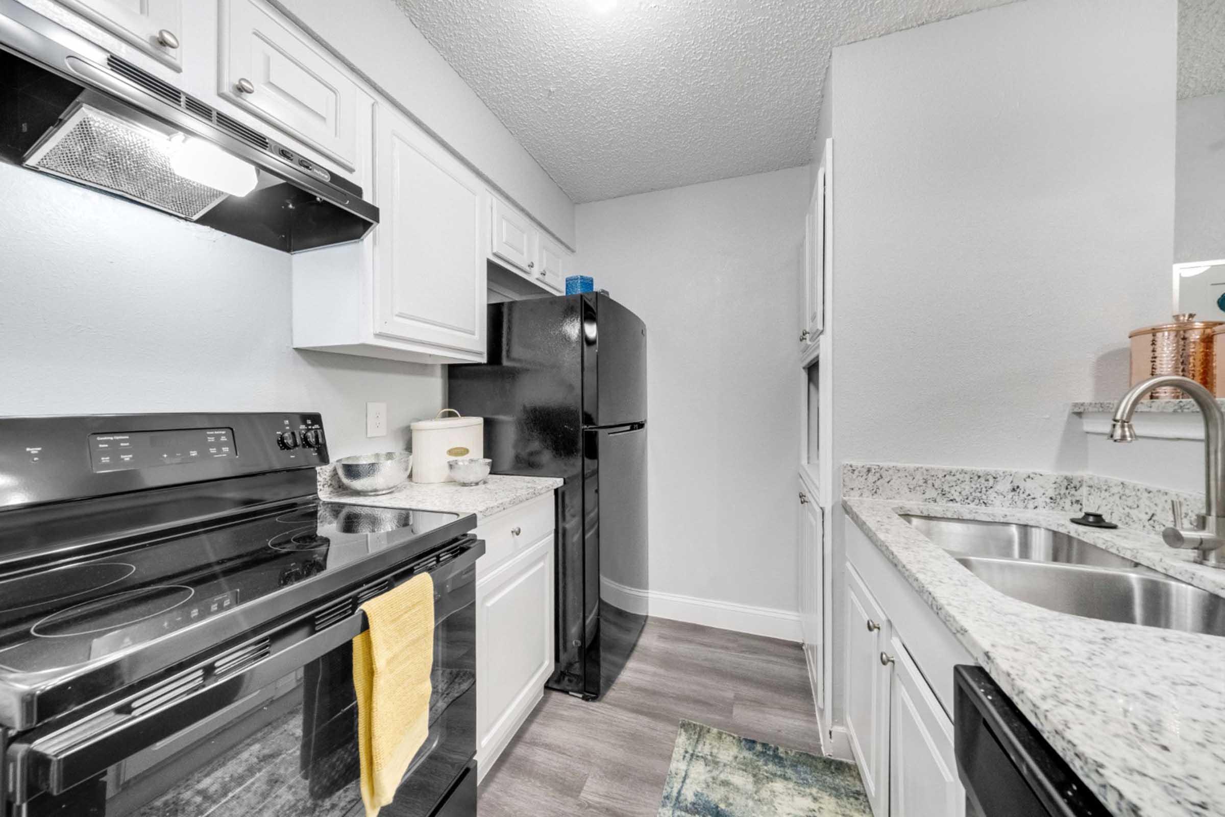 a stove top oven sitting inside of a kitchen