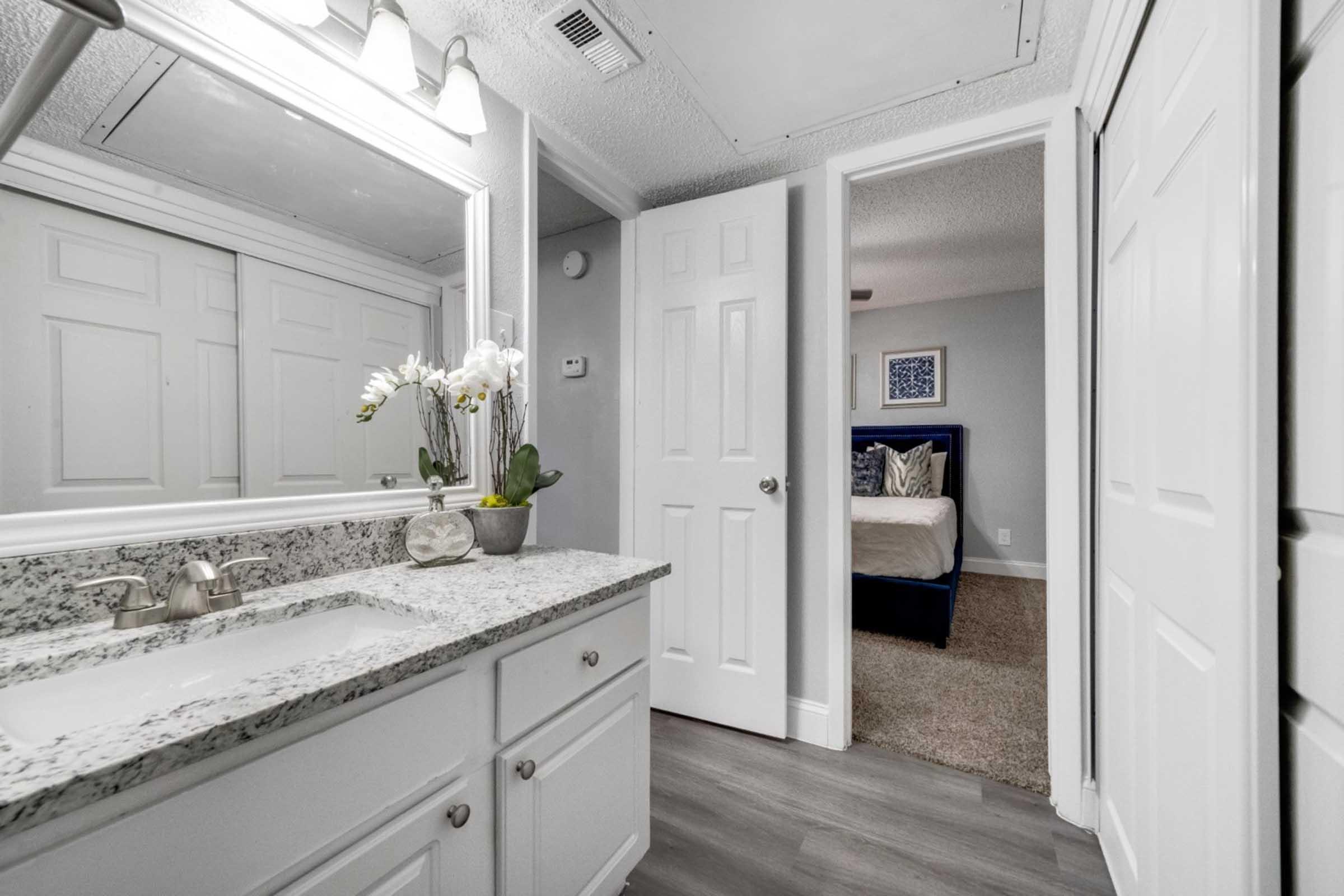 a kitchen with a sink and a mirror