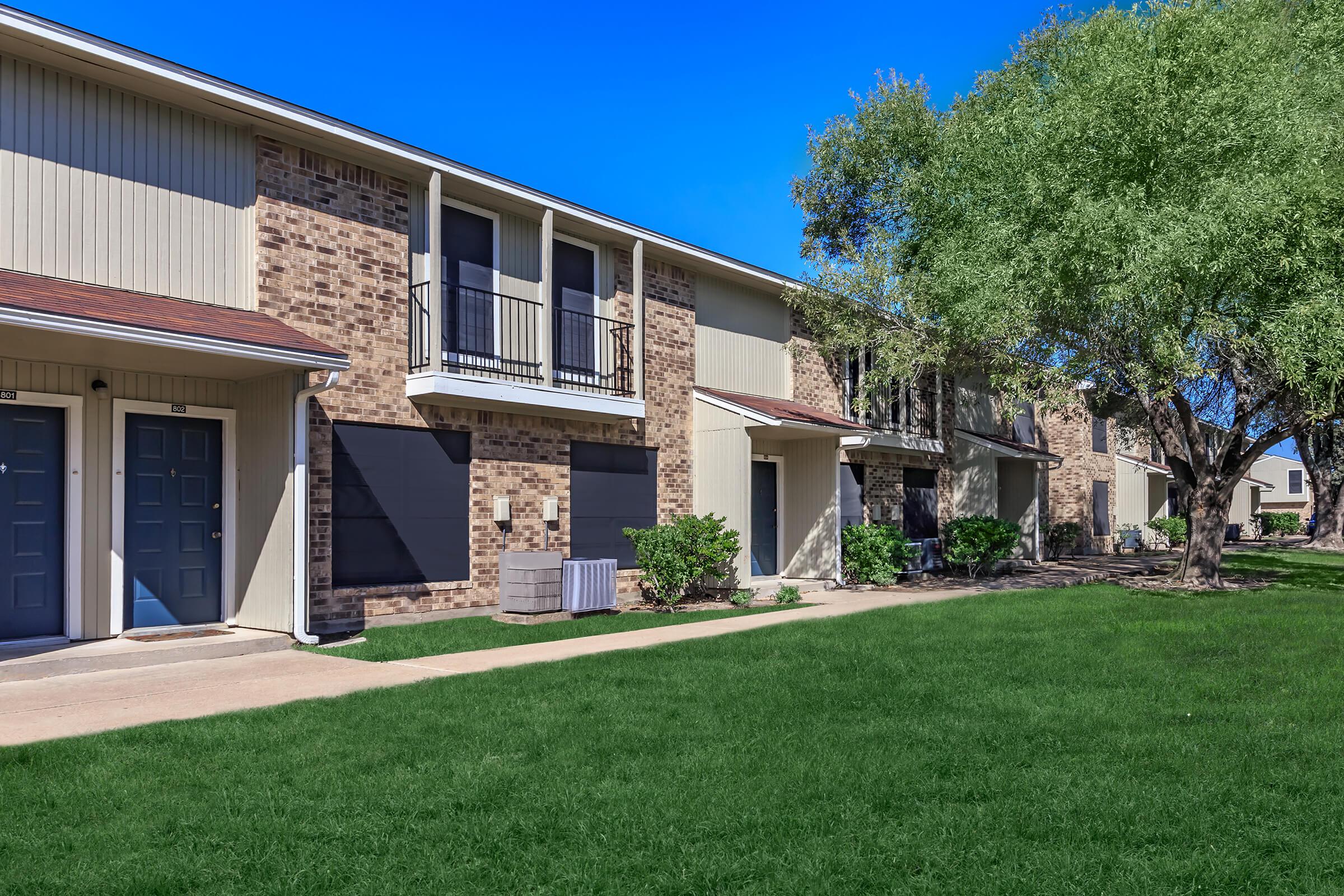 BEAUTIFUL BRICK EXTERIORS AT WOOD TRAIL APARTMENTS FOR RENT IN BRYAN, TX.