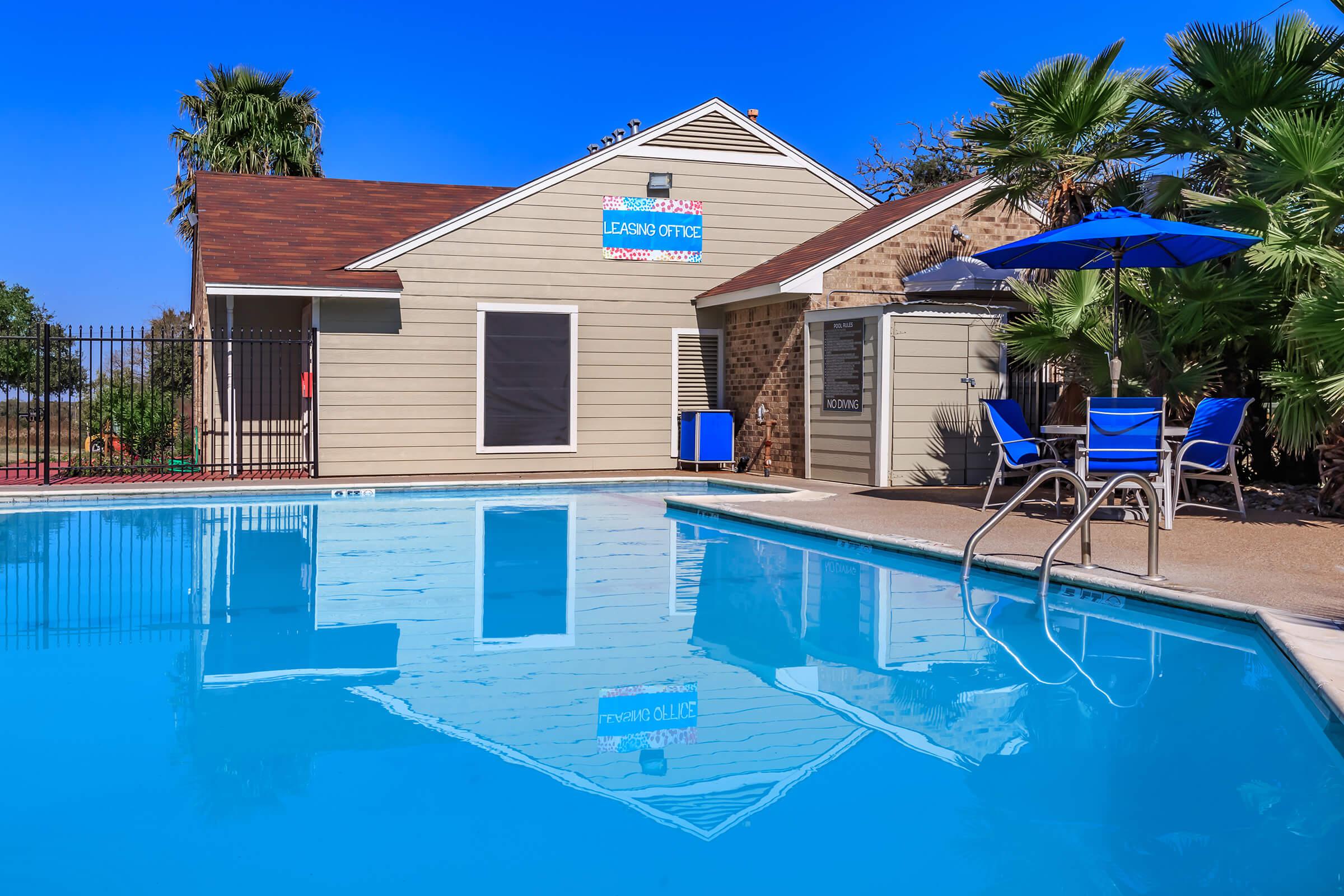 a house with a pool outside of a building