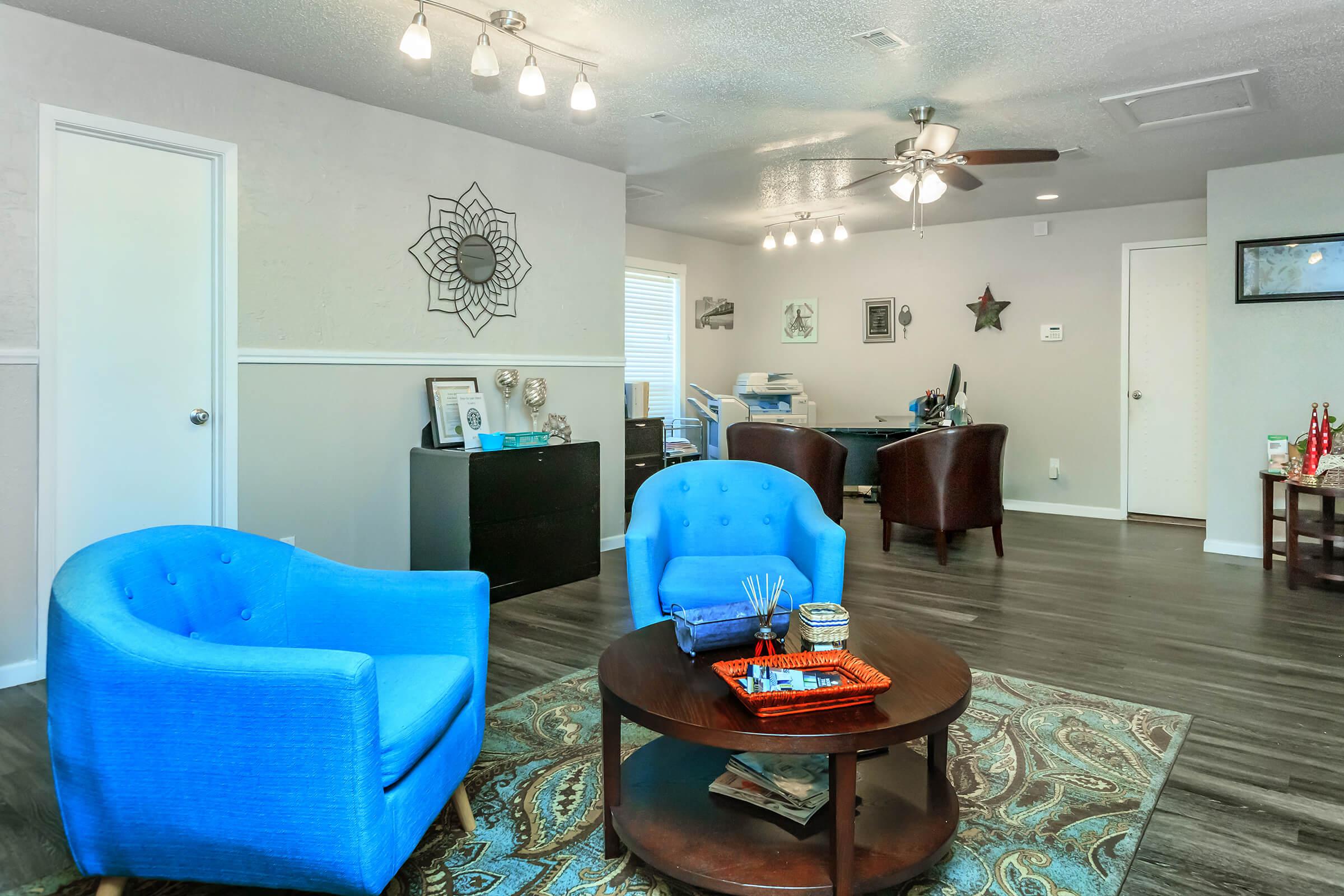 a living room filled with furniture and a blue sky