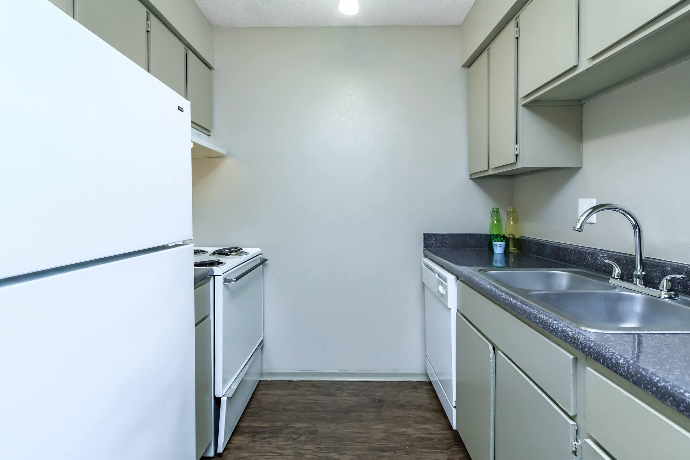 a kitchen with a sink and a refrigerator