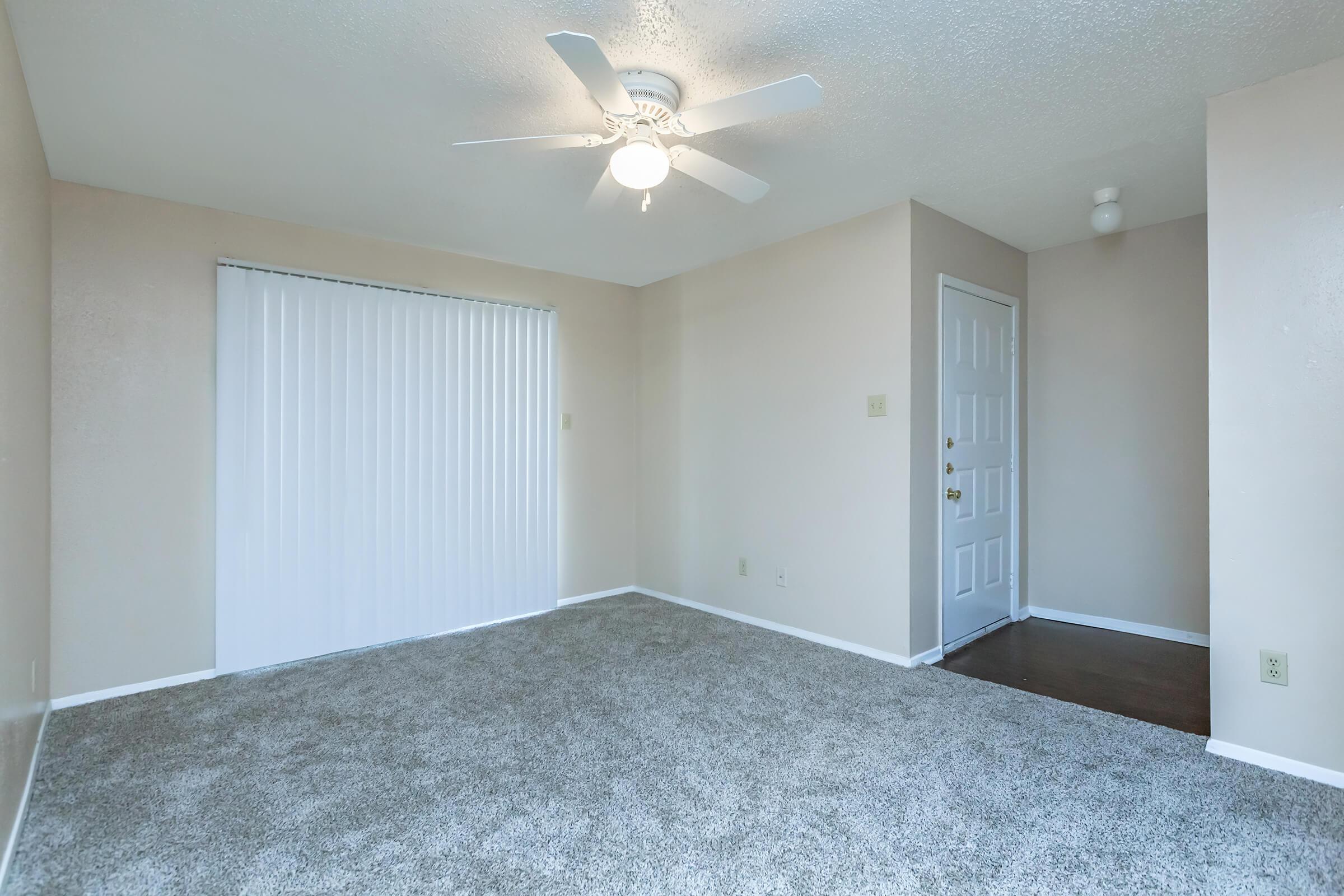 a bedroom with a bed and a mirror in a room