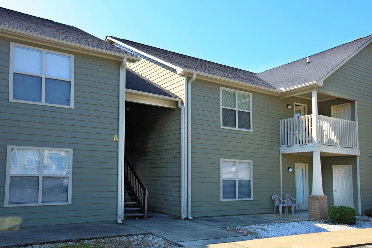 a house in front of a brick building