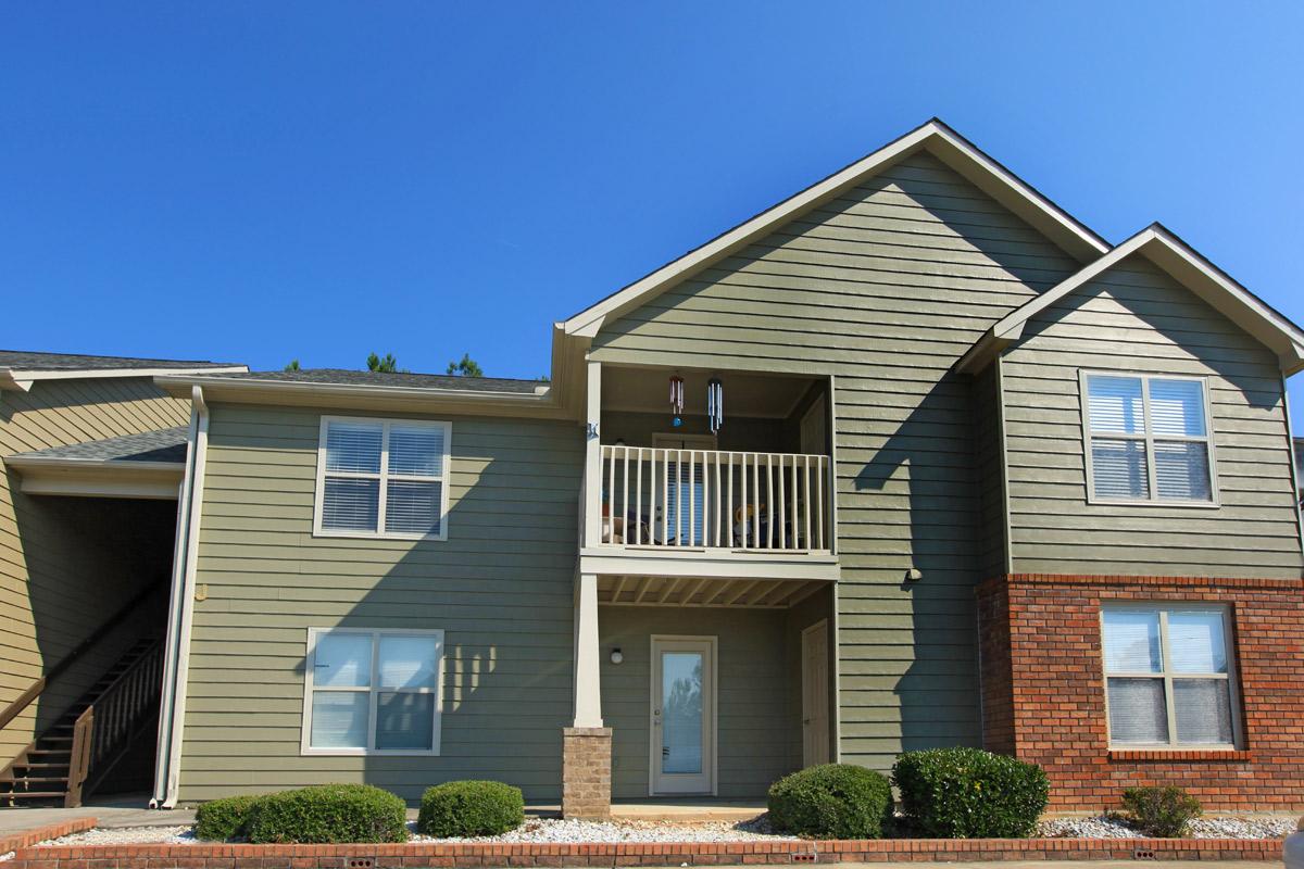 a house in front of a brick building