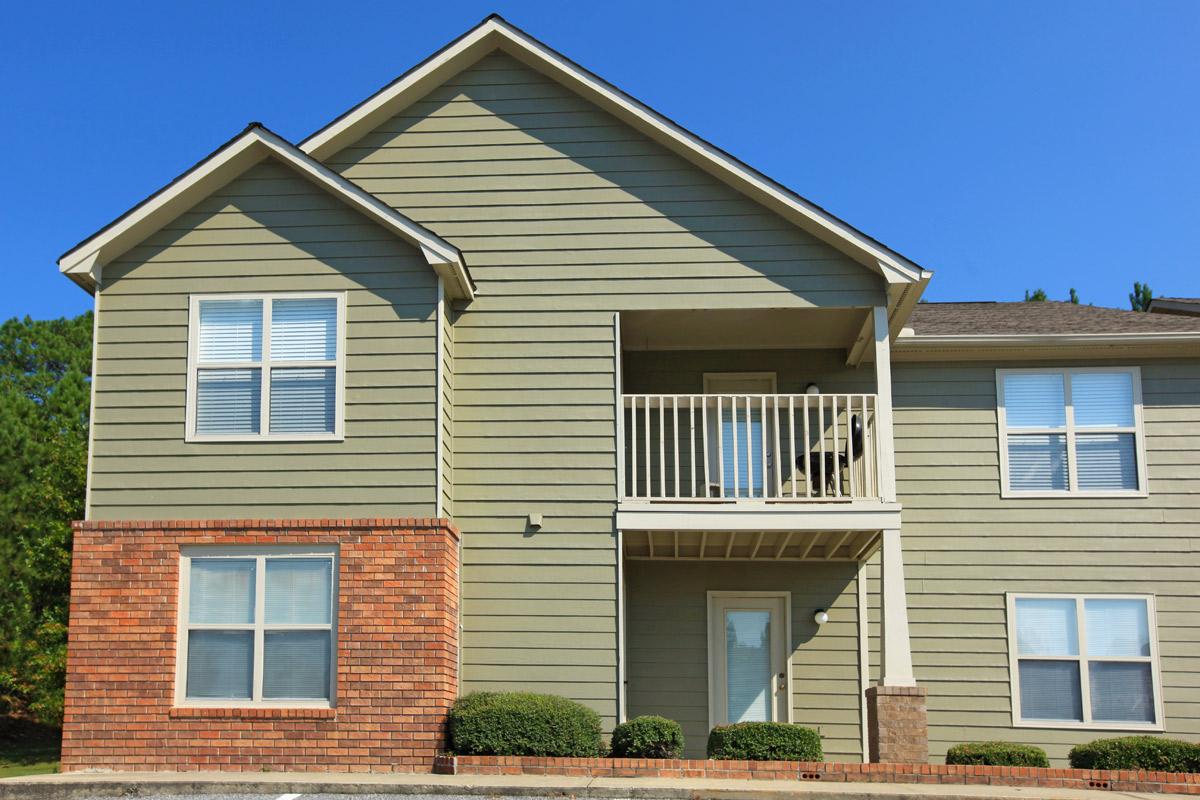 a house in front of a brick building