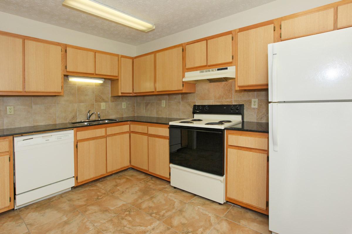 a kitchen with a stove and a refrigerator