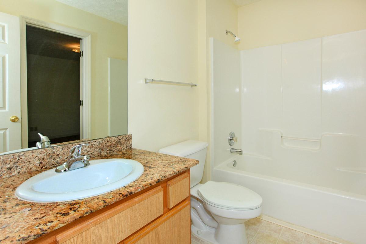 a large white tub next to a sink