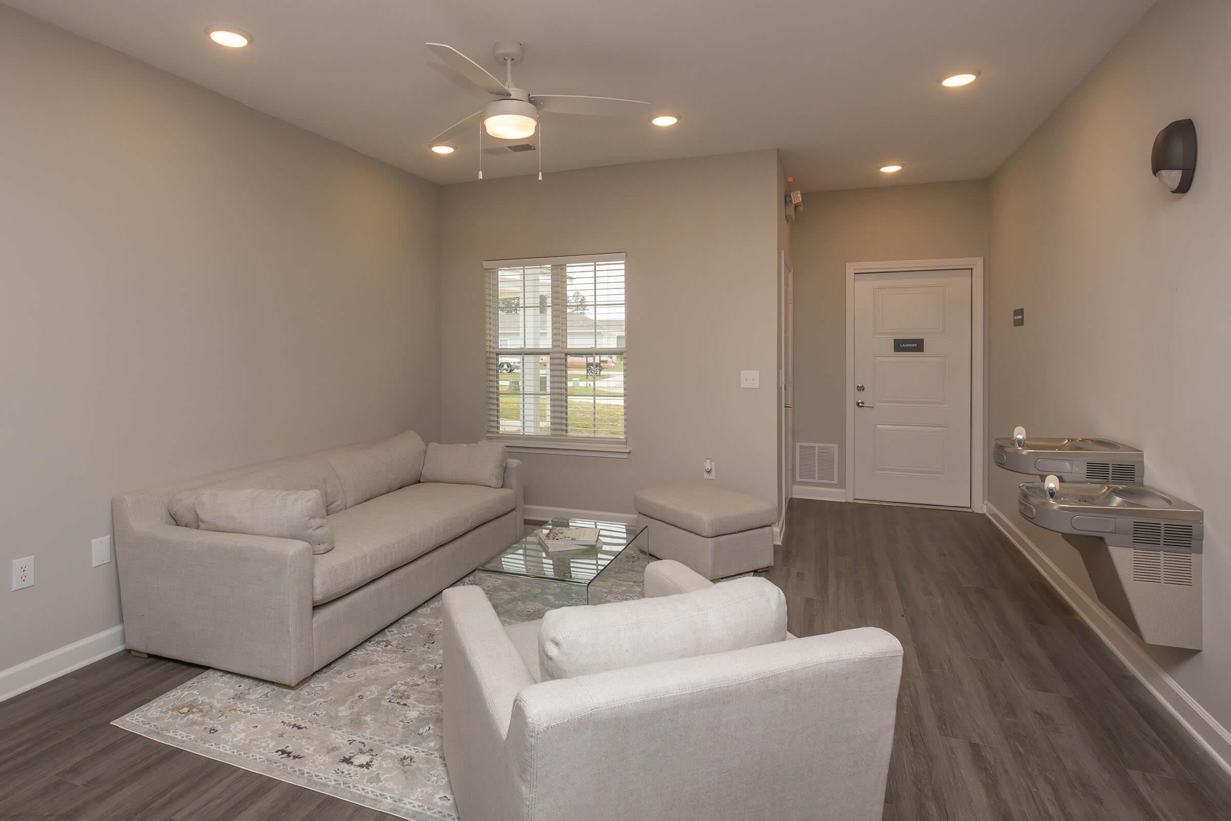 a living room filled with furniture and a sink