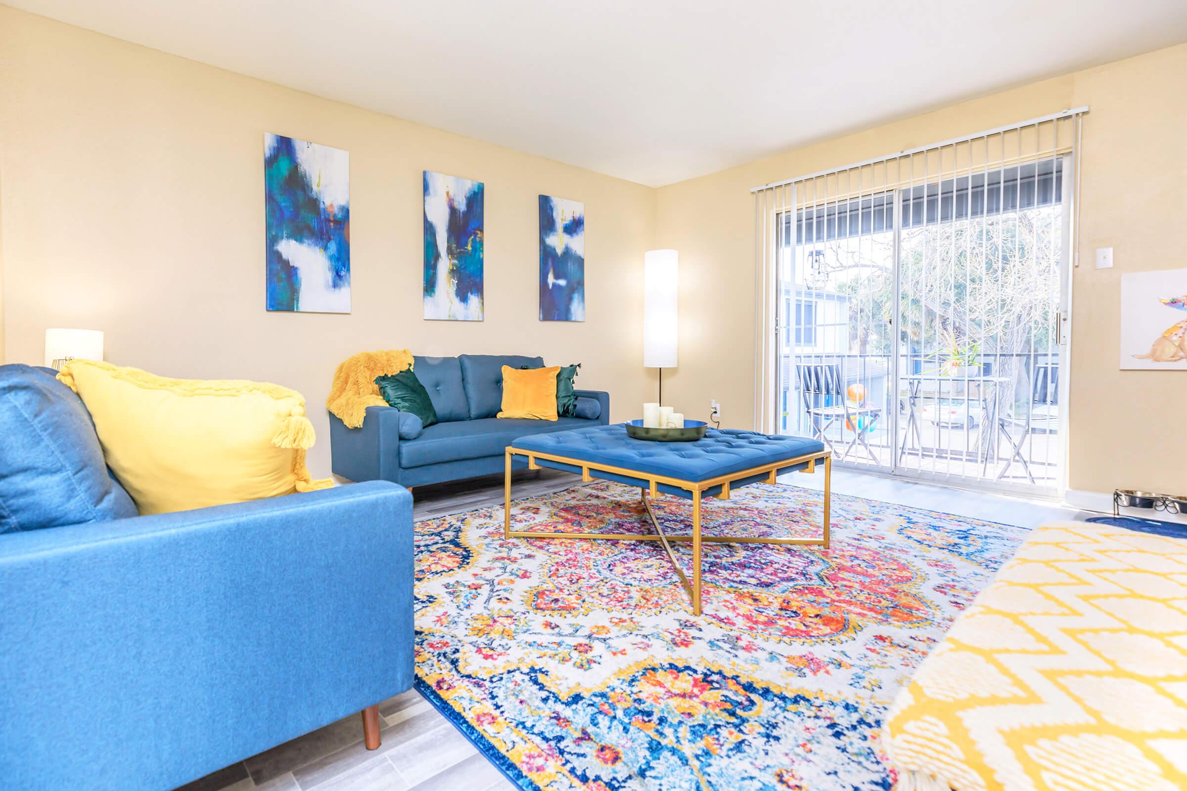 a living room filled with furniture and a rug