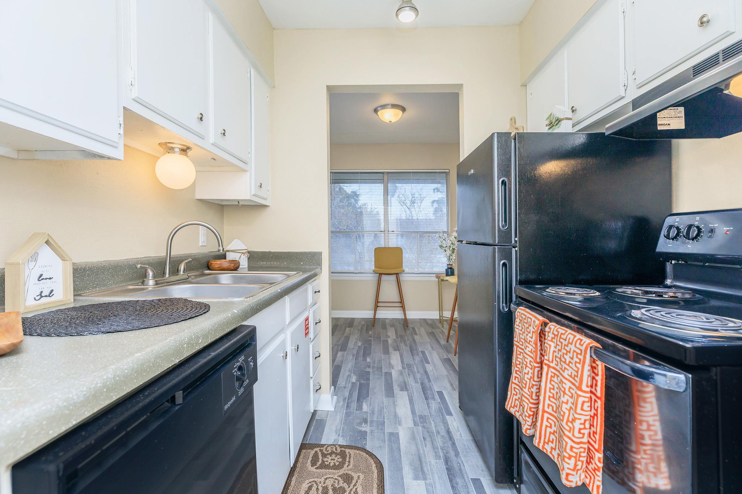 a stove top oven sitting inside of a kitchen