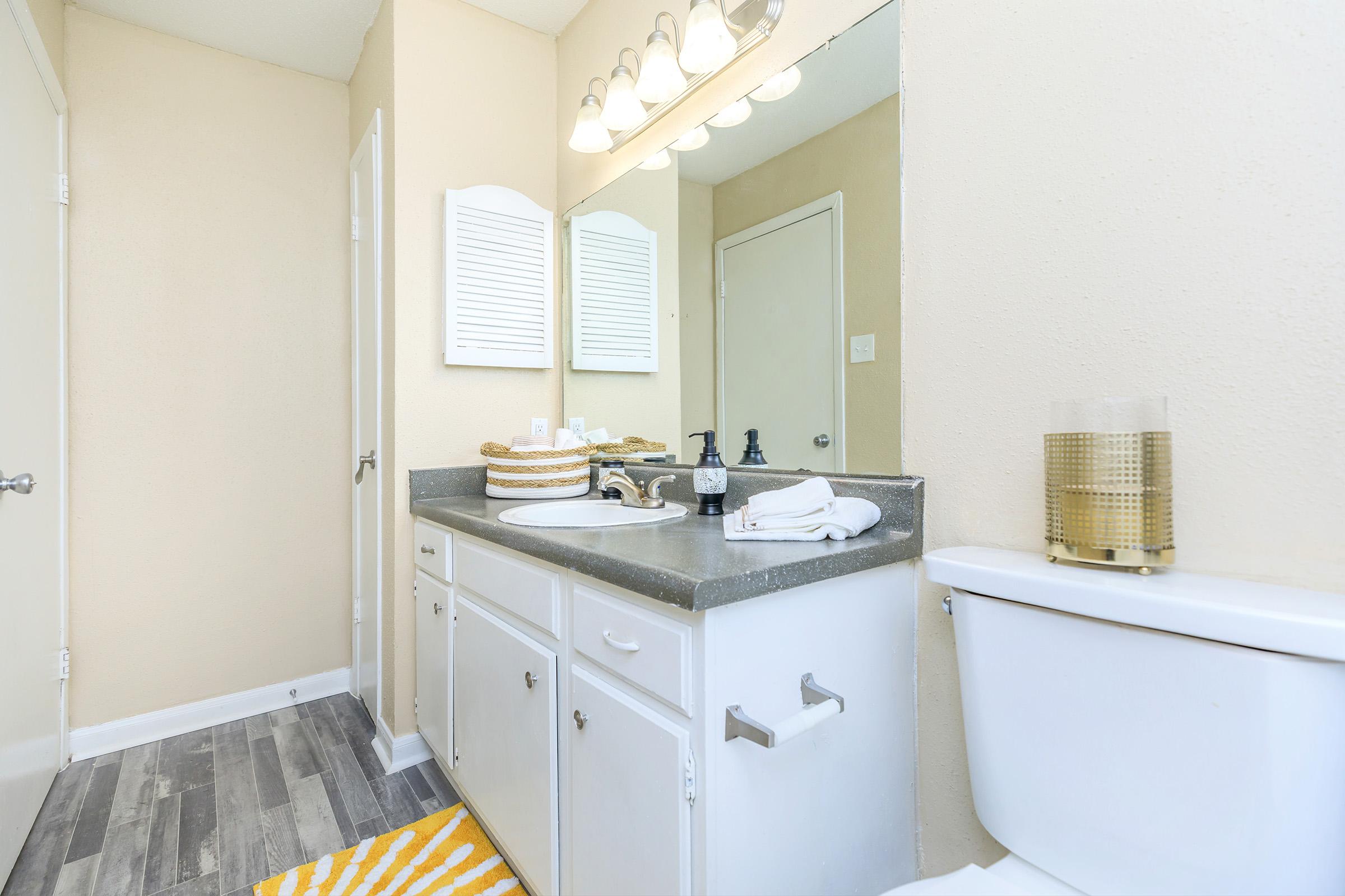 a kitchen with a sink and a mirror